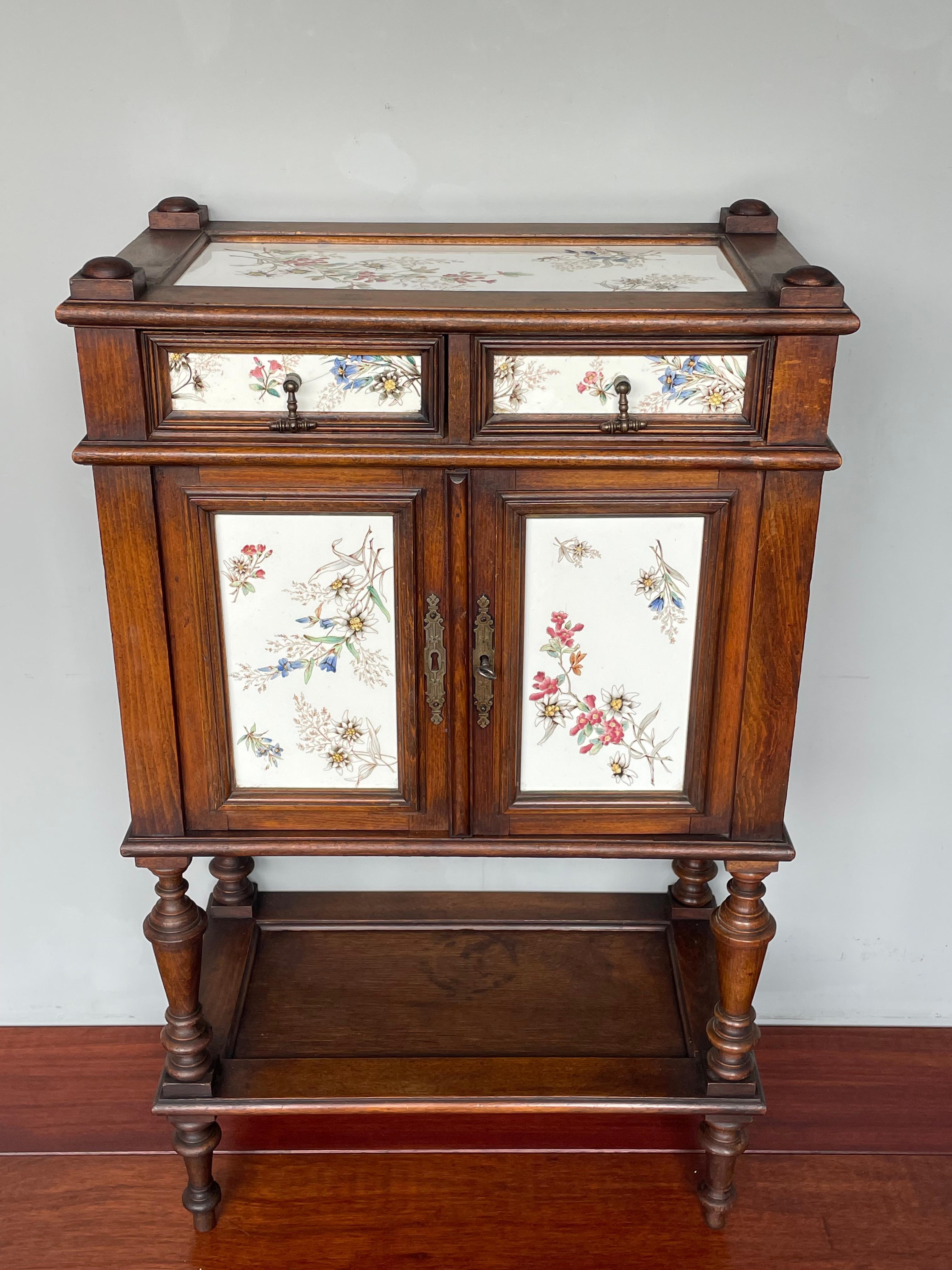 Very rare drinks cabinet with hand-painted & glazed porcelain tiles.

This very good condition and all-original antique cabinet is the only one of its kind that we have ever seen and it could very well be a one of a kind. What makes this work-of-art
