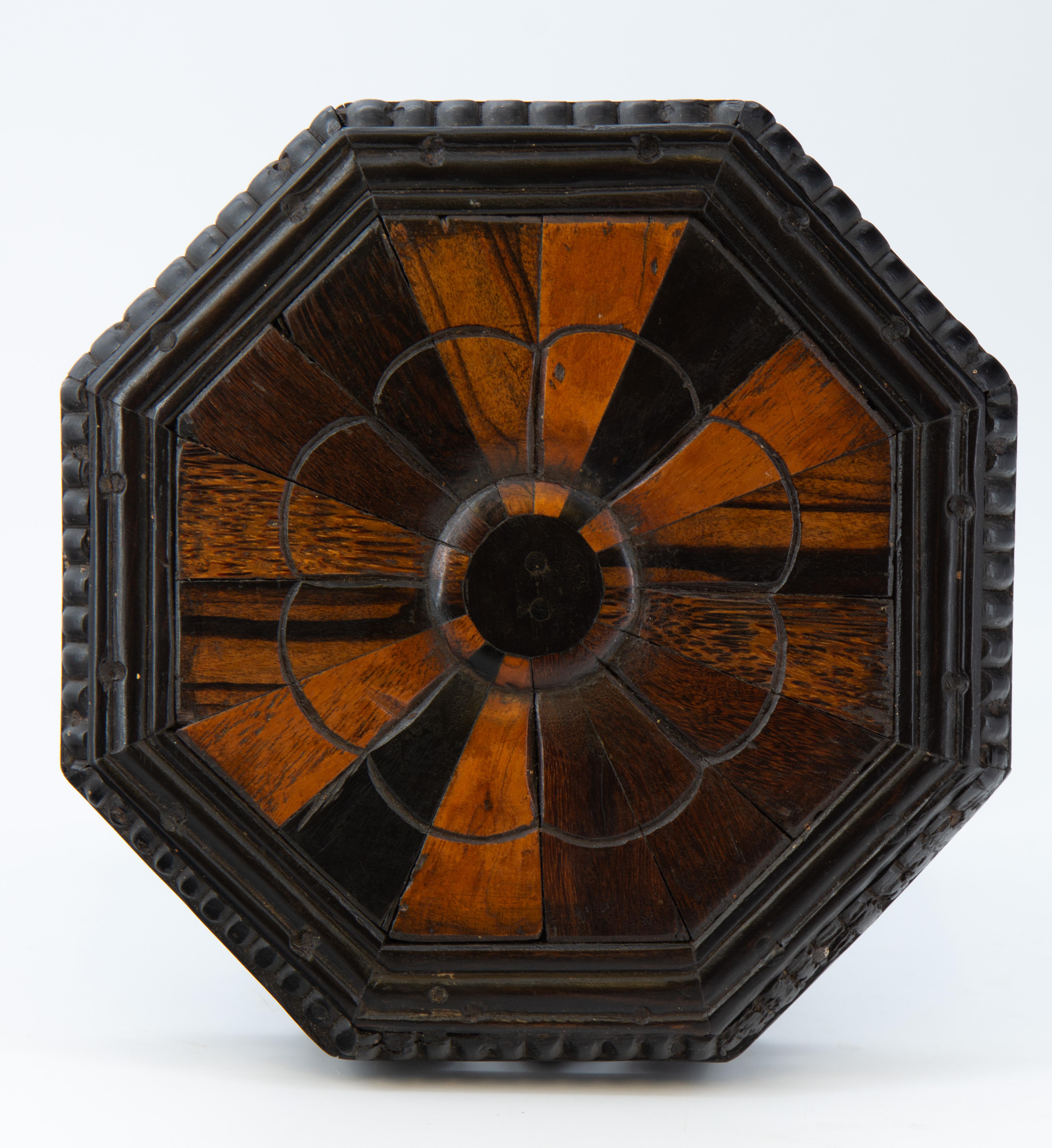 A rare antique ebony and specimen wood miniature octagonal table. Ceylonese/Indian. Circa 19th century.

Free UK delivery via a selected parcel company.

The top is radially veneered with exotic woods including Coromandel Ebony, Sal wood and