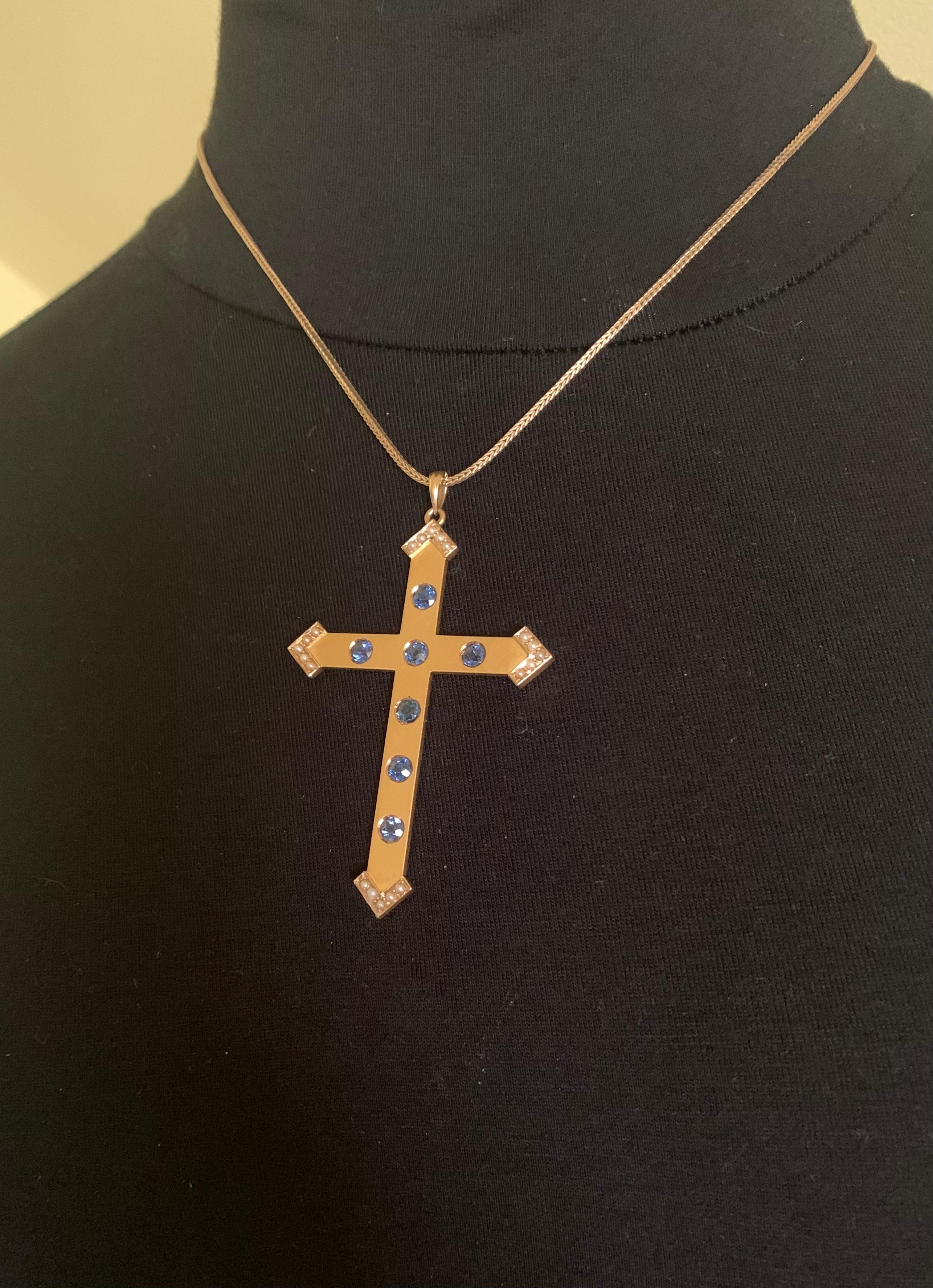 Fine and rare antique Edwardian sapphire, natural pearl and 14K yellow gold Disciples cross
Early 20th Century
The unusual design of this beautiful cross features an arrow motif at the arms, rich in symbolic meaning. In Christianity, arrows