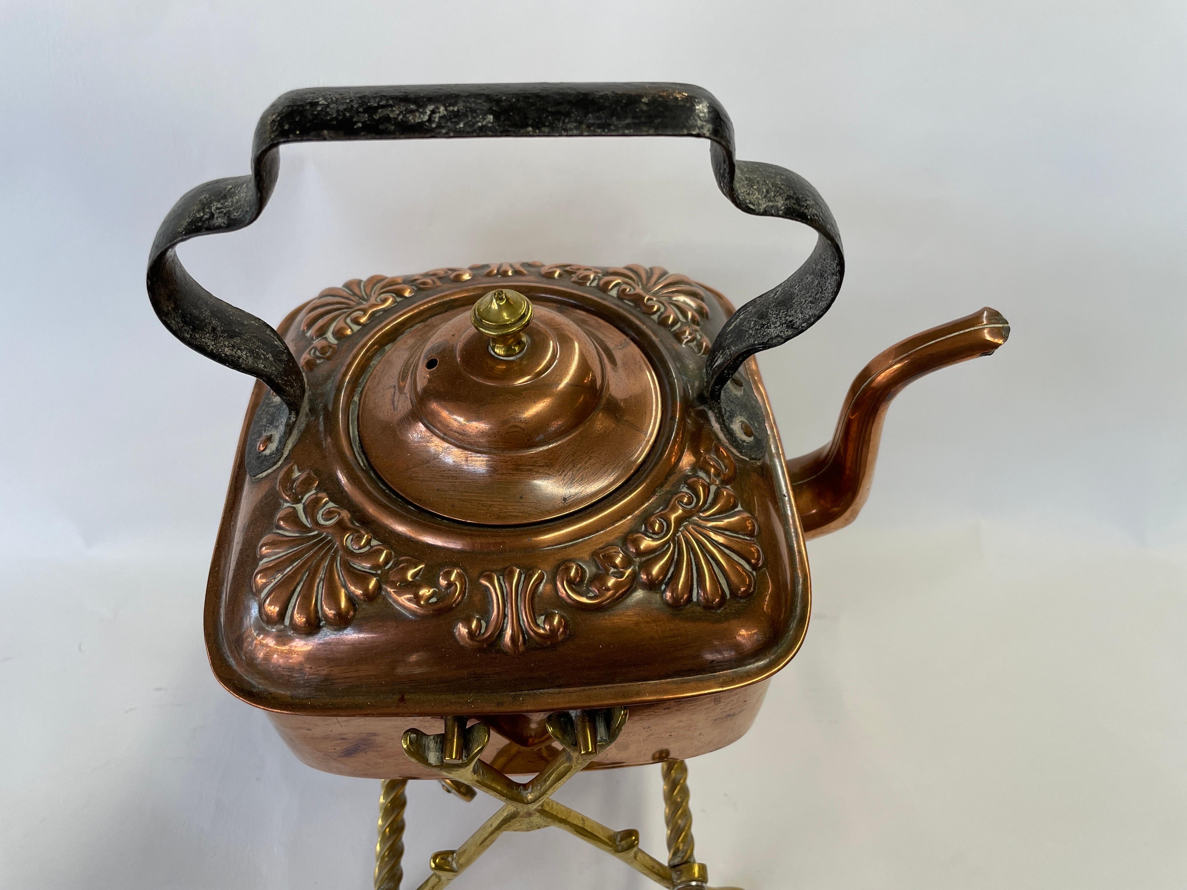 Gorgeous Antique English Arts & Crafts or Aesthetic Movement hand chased copper and wrought iron square tea kettle on its original brass barley twist stand with original copper burner. The dimensions shown are the overall dimensions with the kettle