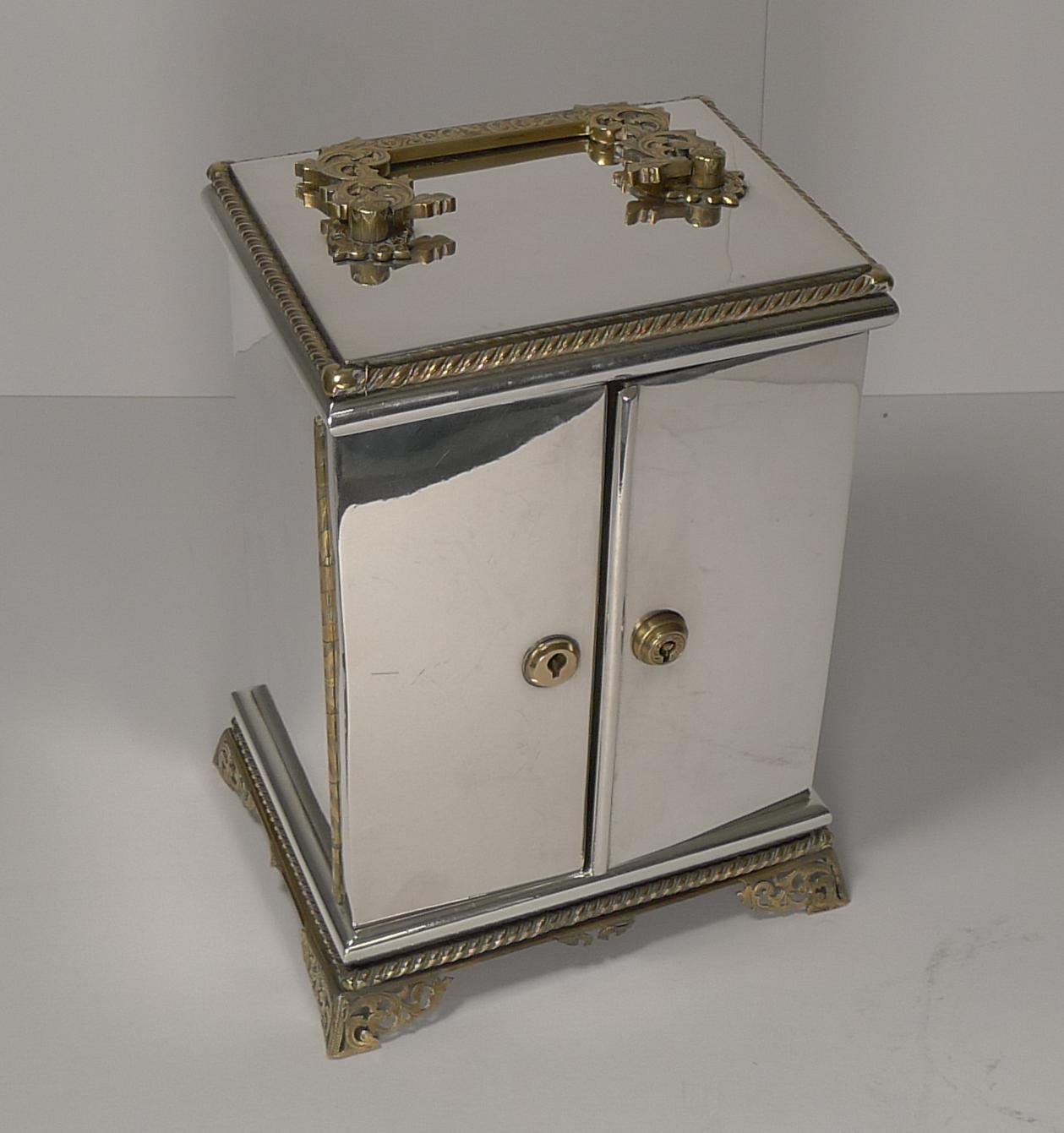A gem of a box, this English Victorian table cabinet is made from silver plate and gilded bronze fittings, exquisite quality.

The top has the most beautiful handle, pierced and engraved to compliment the lovely feet and the engraved full length
