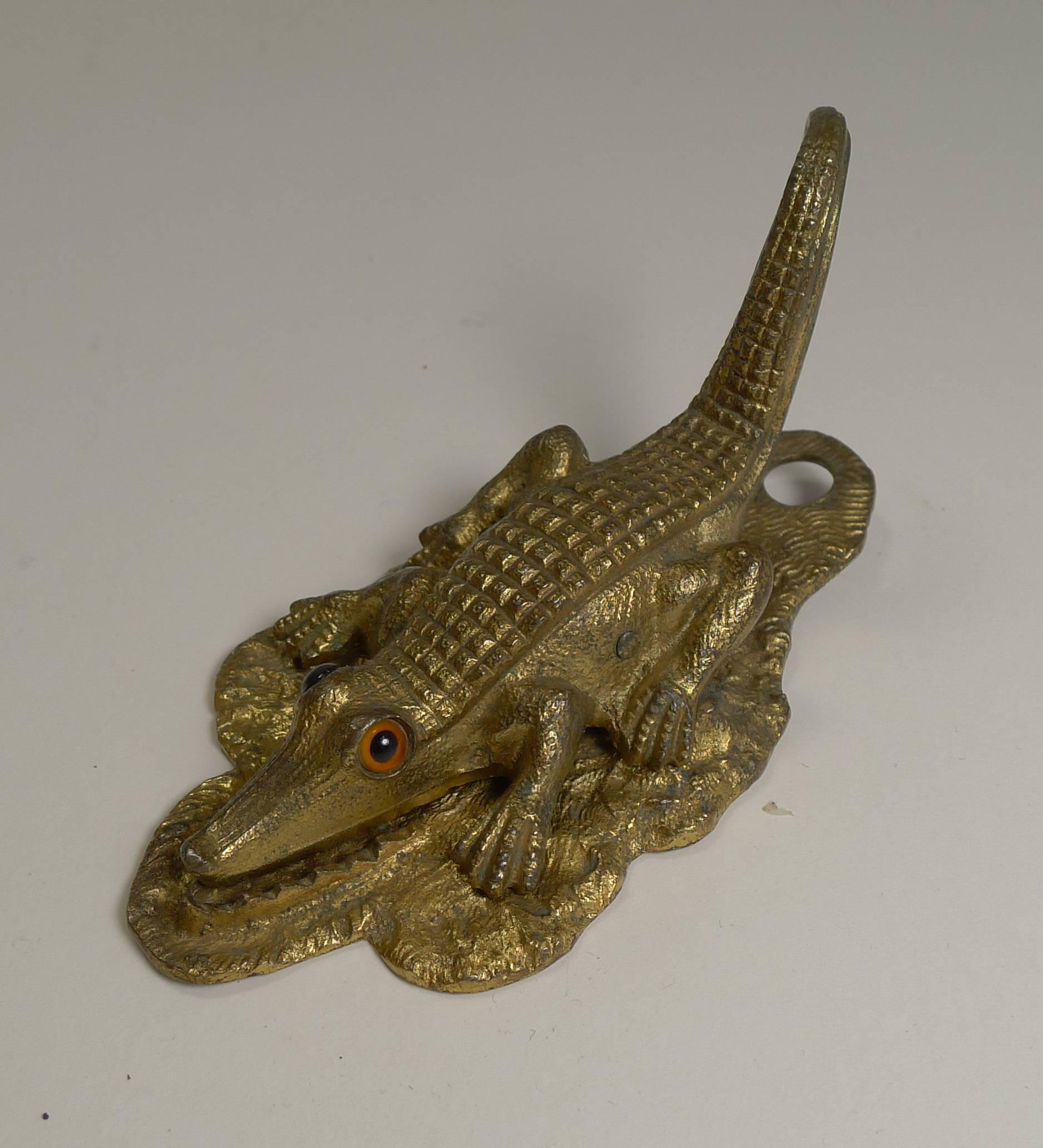 These figural letter or paper clips in the form of a Crocodile or Alligator scarcely come along, made from brass with a good original untouched patina and sporting two glass eyes.

The underside is lucky enough to have the English registration