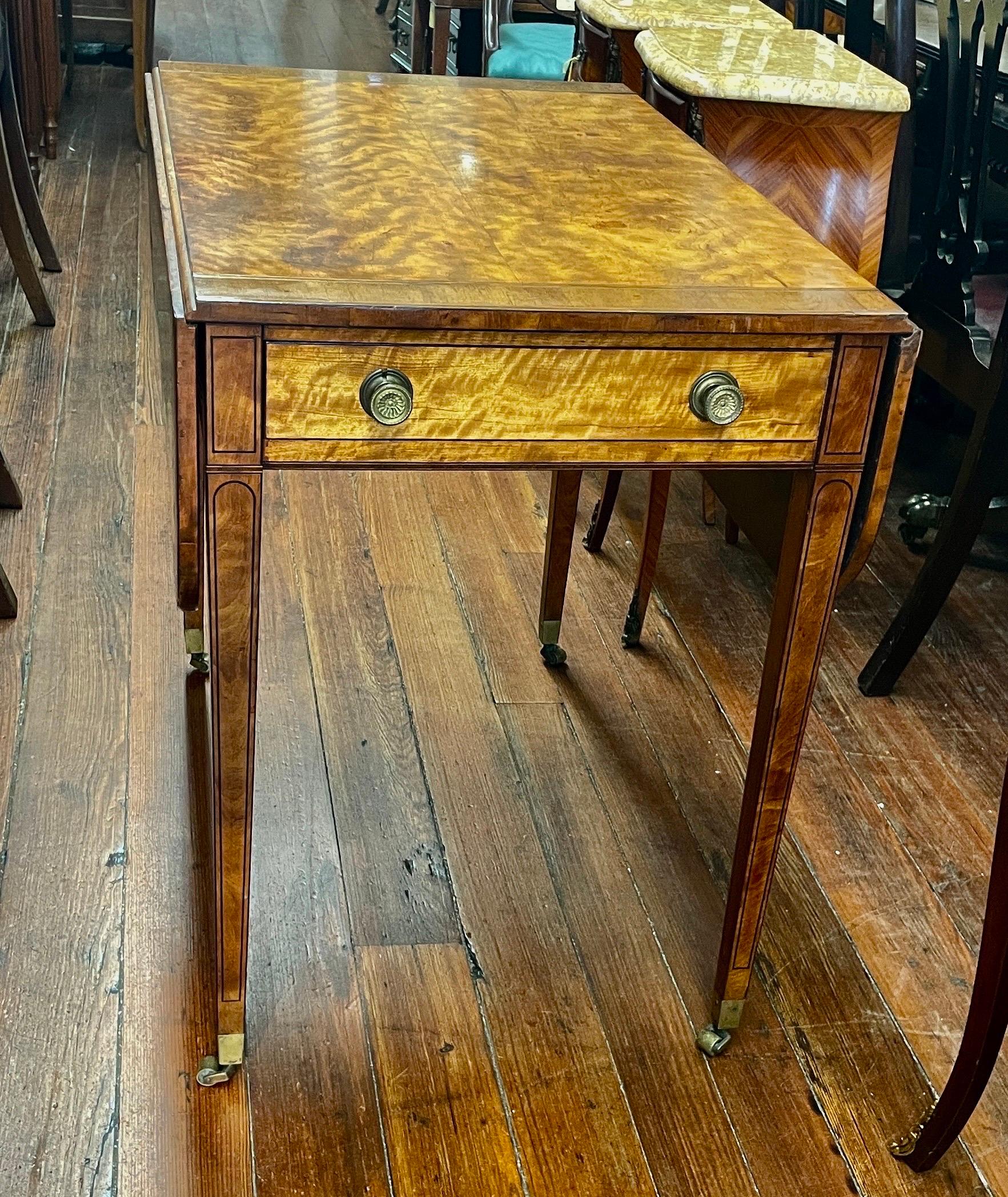 A true rarity, a marvelous Antique English Regency period Geo. III Rosewood inlaid Satinwood Drop-Leaf Pembroke Table with what appears to be cedar lined drawer; original chased ormolu brass round knobs front of drawer and faux backside. In the