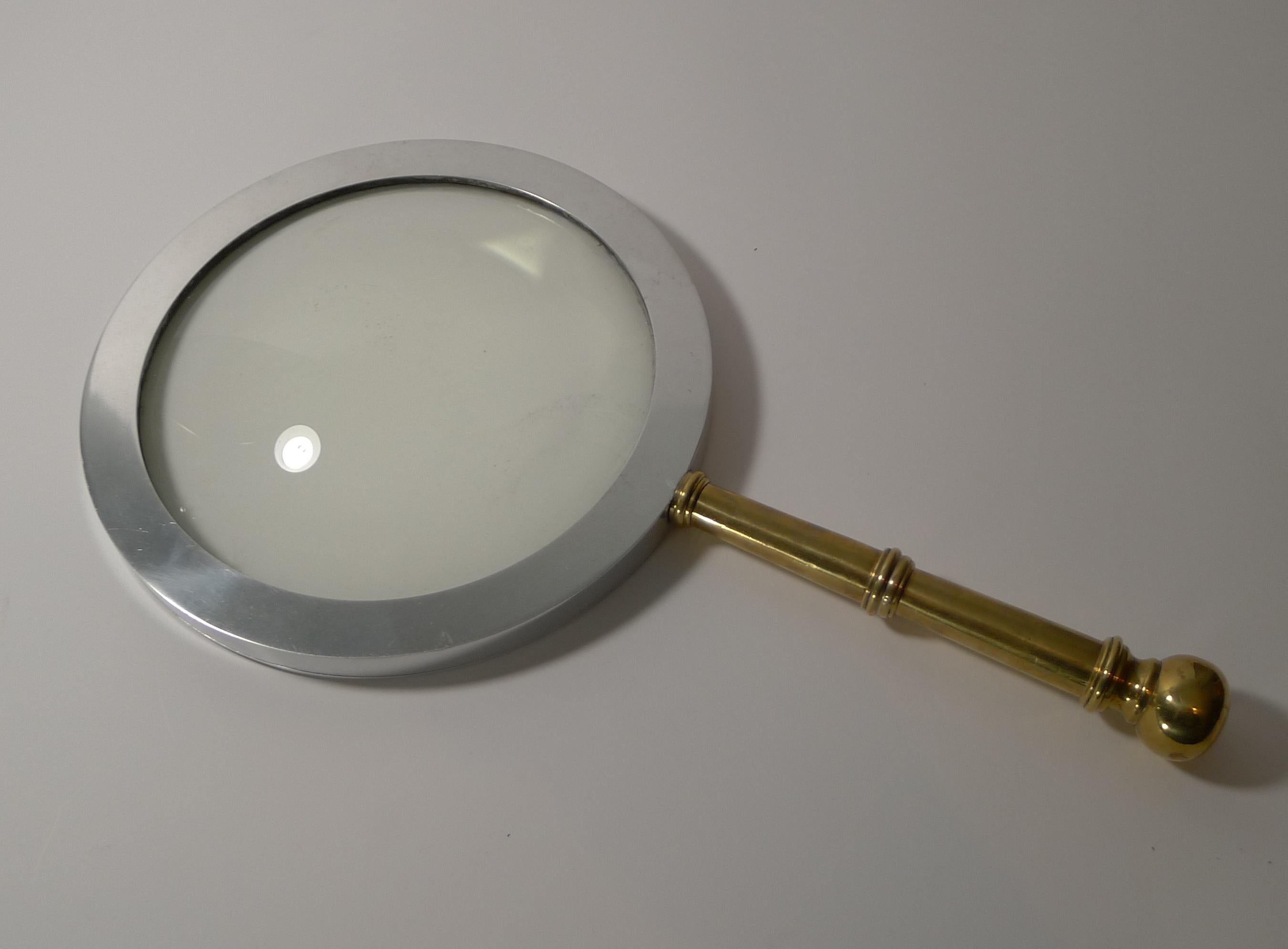 Wow, you need to hands to lift this mammoth magnifying glass, a great look for the library and a real talking point.

The handle is made from cast brass and the frame for the glass a polished steel with a screwed construction keeping this huge