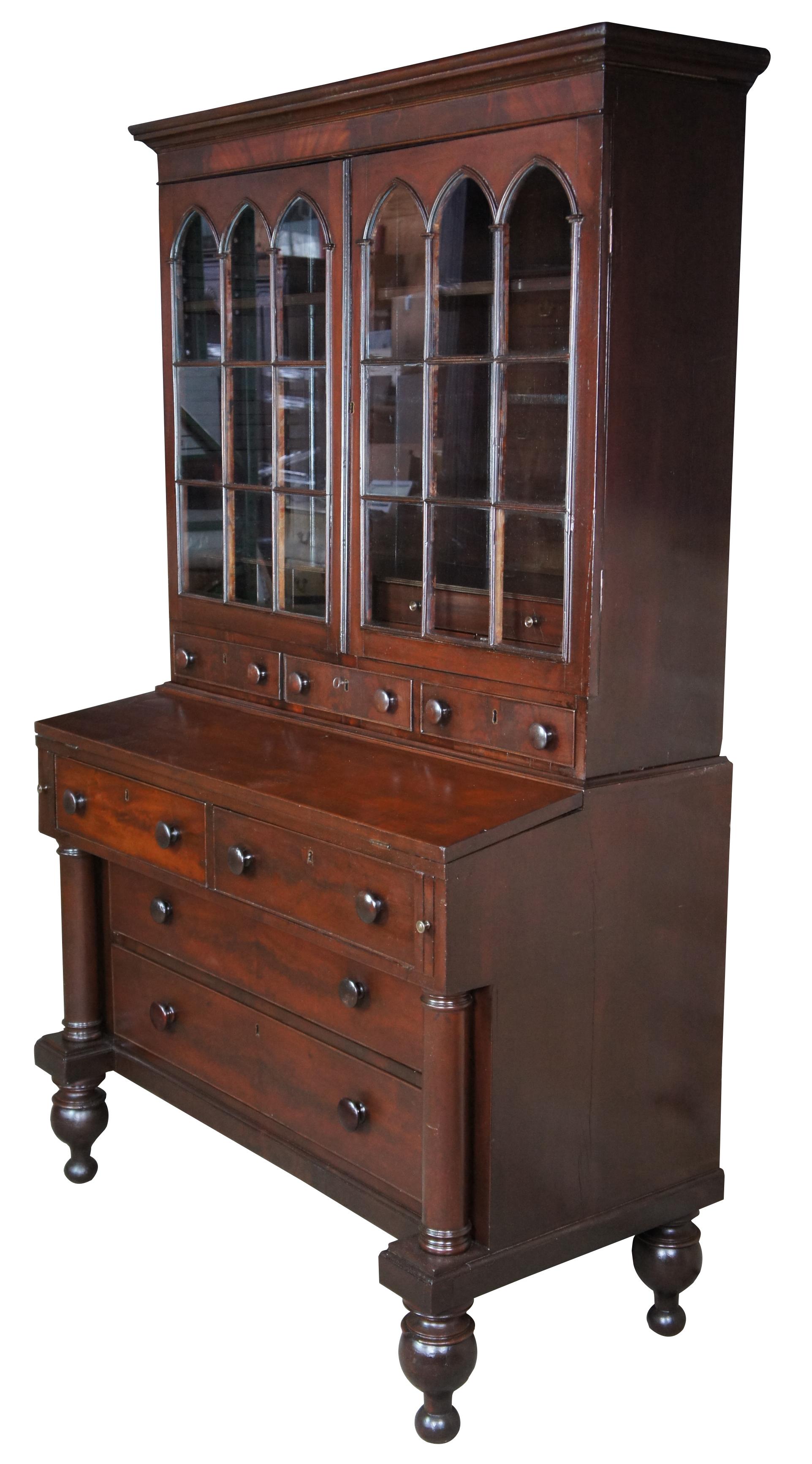 A fine and impressive Federal Period Mahogany secretary and bookcase, circa 1830s. The bookcase features an eighteen pane gothic arched cabinet front that opens to two shelves, cubbies and drawers. A flip top writing surface opens to a baize writing