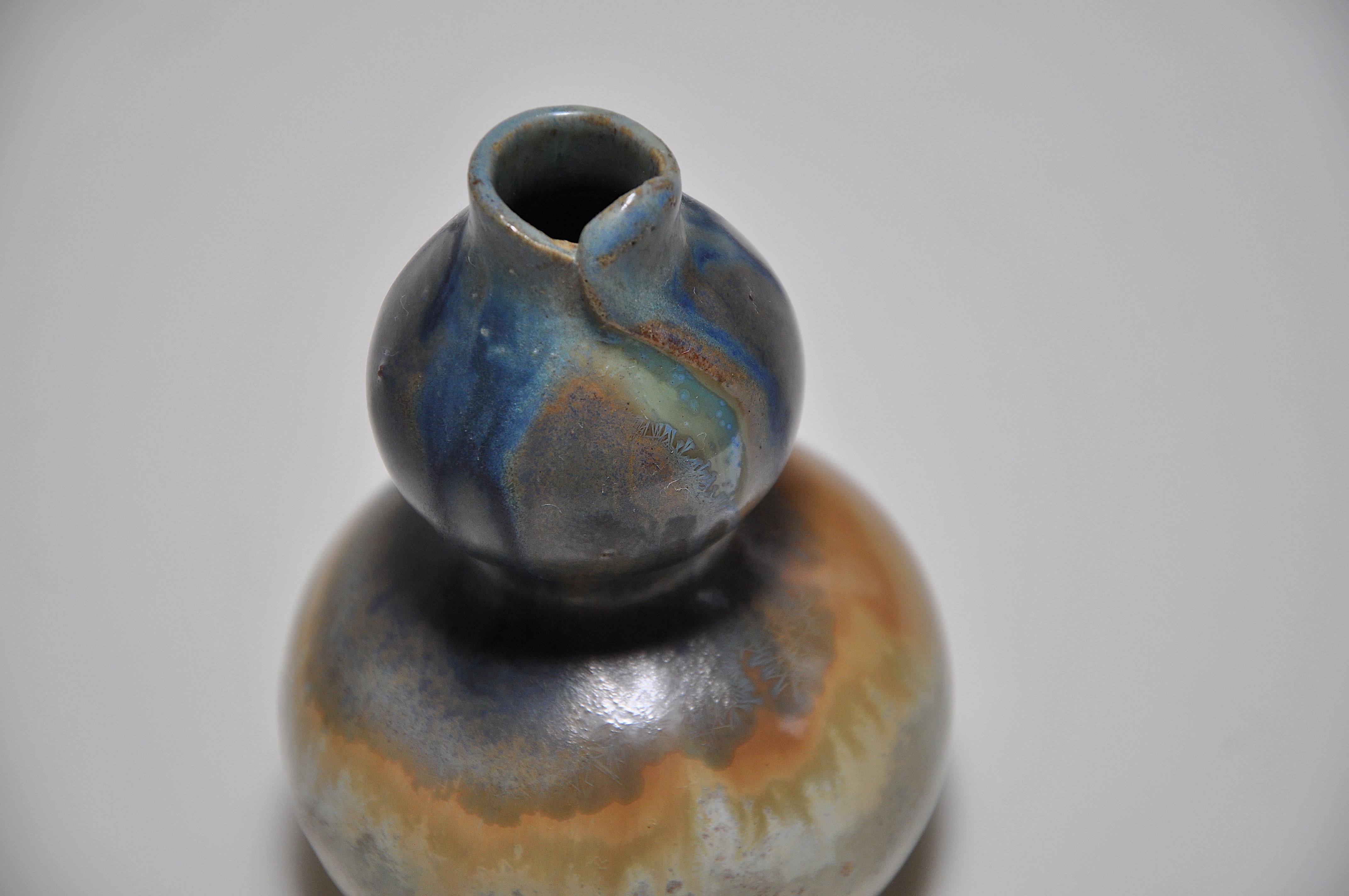 A small but rare stoneware vase of double-gourd Japonist form and organic character, freely treated at the top rim where it is a rare example of a cut and overlapped fold, reminiscent of a phallic shape or even the delicate petals of a flower. It