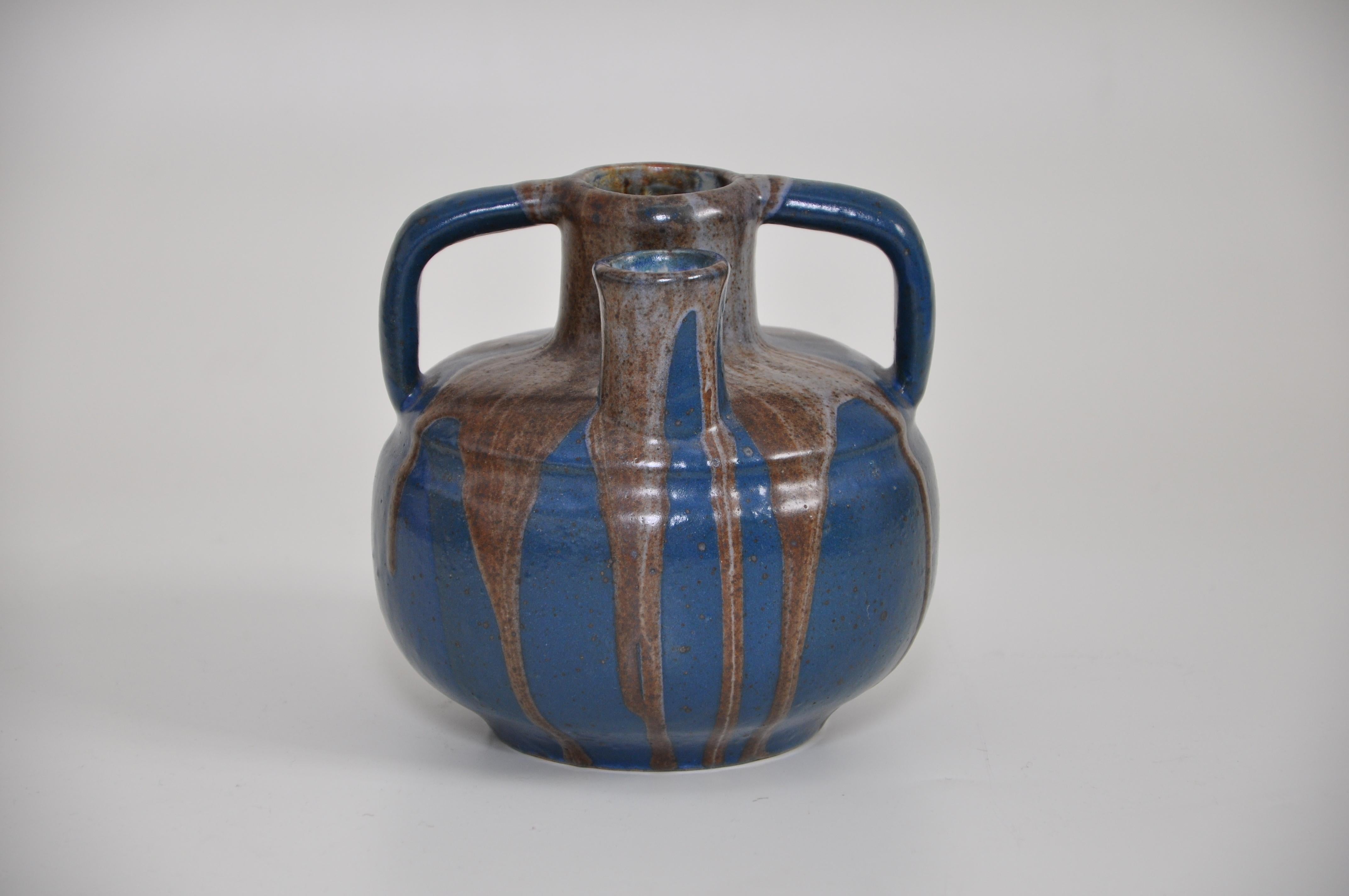 A large stoneware vase of Japoniste inspiration, of rare double-spout form with twin handles, covered with a flowing brown and pale blue drip-glaze over a deep blue body, by the French art ceramist Leon Pointu (1879-1942), the son of Jean Pointu (a