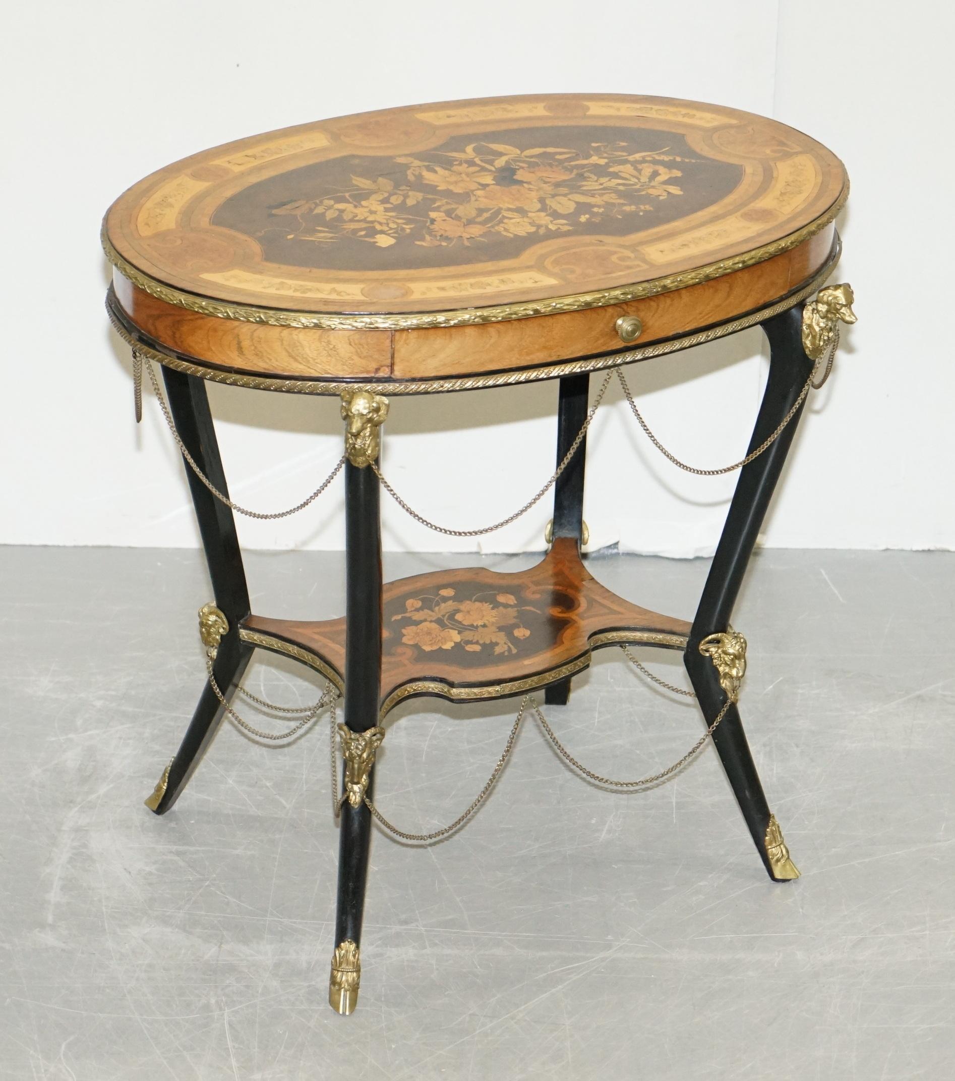 We are delighted to offer for sale this lovely, highly decorative antique 19th century tulipwood, burr walnut ebonised and marquetry inlaid centre table with gold gilt bronze rams heads, feet and dogs bust decorations after Auguste Maximilien
