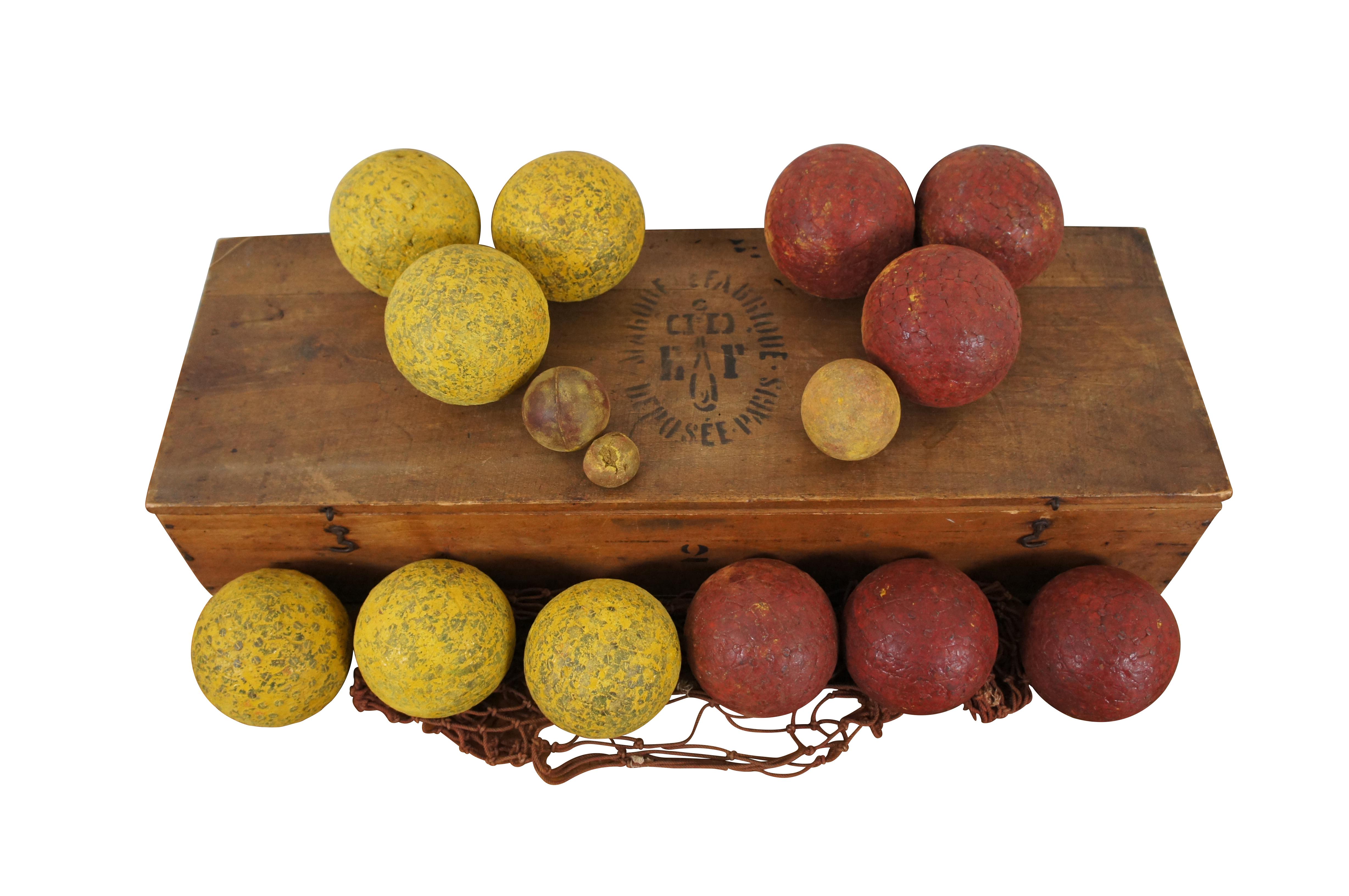 Antique 17 piece Jeu de Boules / lawn bowling / bocce set including original storage crate with instructions and point counter / abicus,12 nail studded playing balls (6 yellow and 6 red), one macrame net bag, and 3 assorted smaller balls for use as