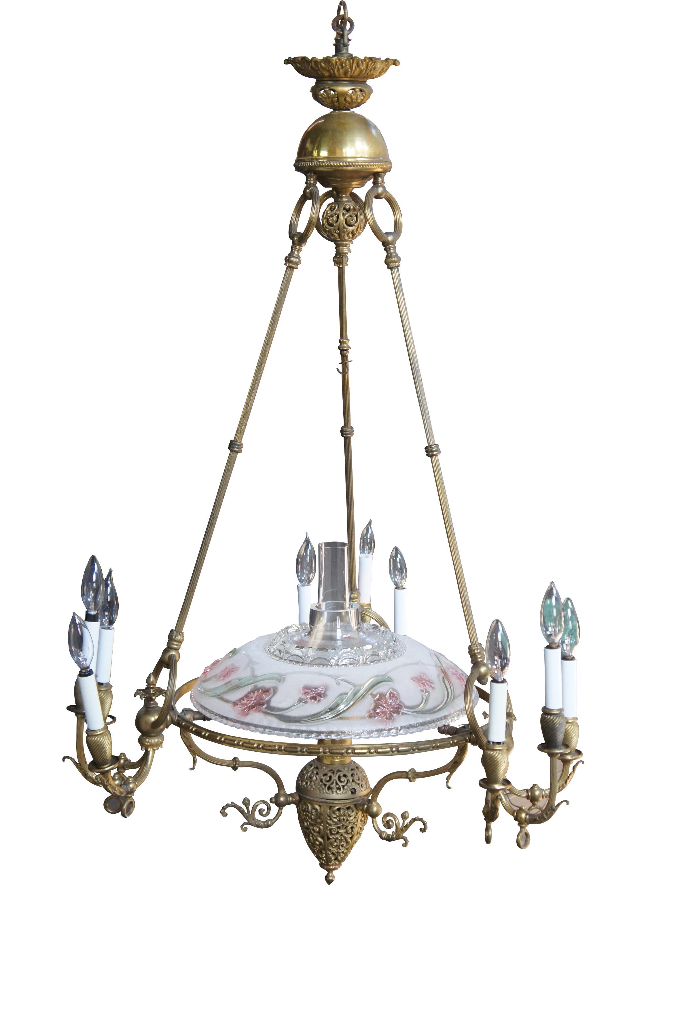 An impressive Victorian era Neoclassical converted gas chandelier.  Made from brass with ornate filigree throughout.  The chandelier is supported by an acanthus medallion that leads to a reverse urn over reeded rings and rods.  The three rods lead