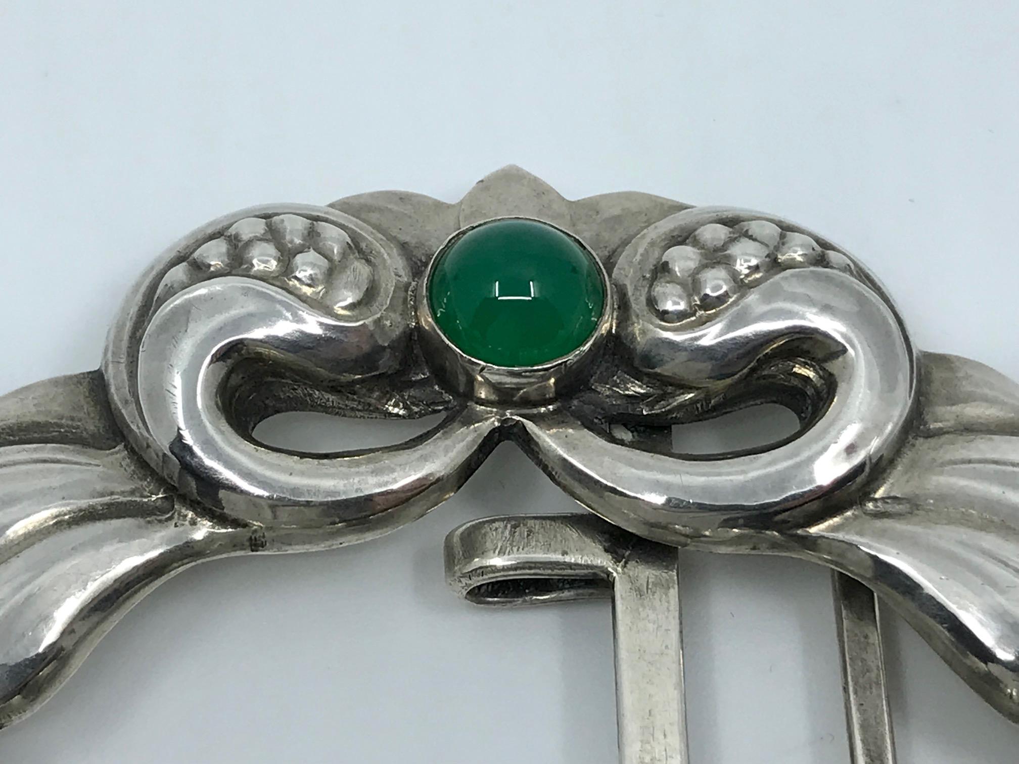 Rare antique 828 silver Georg Jensen belt buckle with cabochon set amber and green agate stones, design #28 by Georg Jensen.
Measures 3½” x 2½” (8.8cm x 6.2cm).
Antique Georg Jensen hallmarks from 1908-1914, 828s.