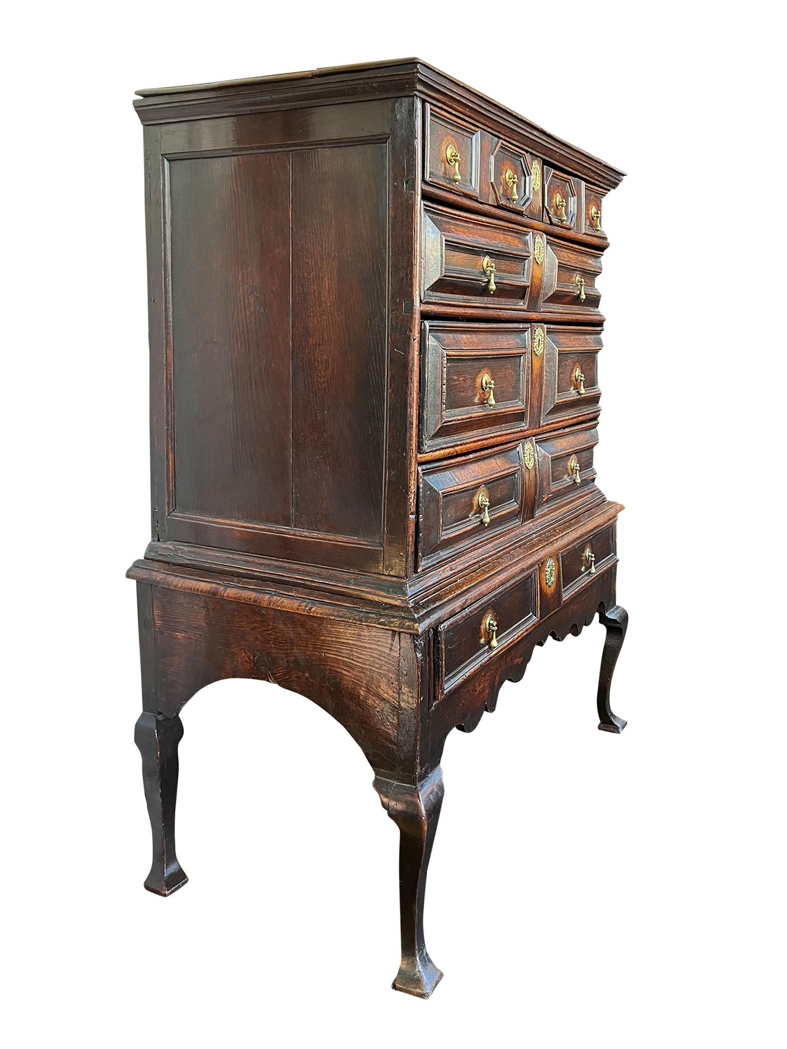 Exceptional and rare Queen Anne or George II era Oak Chest of Drawers on Stand, made in England circa 1720. Crafted in solid oak that has distressed into a warm honey patina over time, this two piece chest is designed with five functioning drawers
