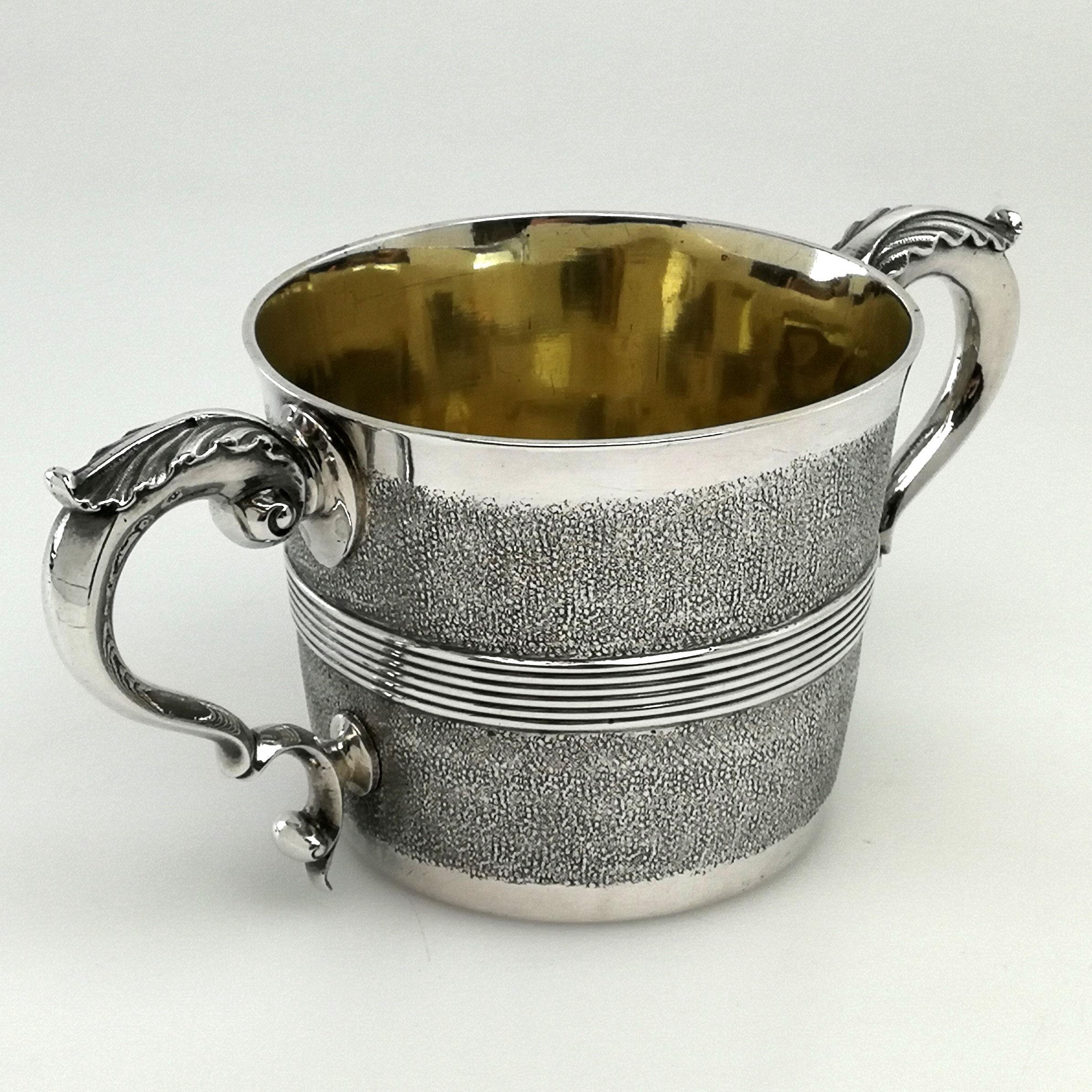 A rare antique George III solid silver Cup with two impressive acanthus leaf scroll handles. The exterior of the cup is embellished with a granulated texture and has an applied reeded band around the centre. The cup is gilded in the centre. 
 
 Made