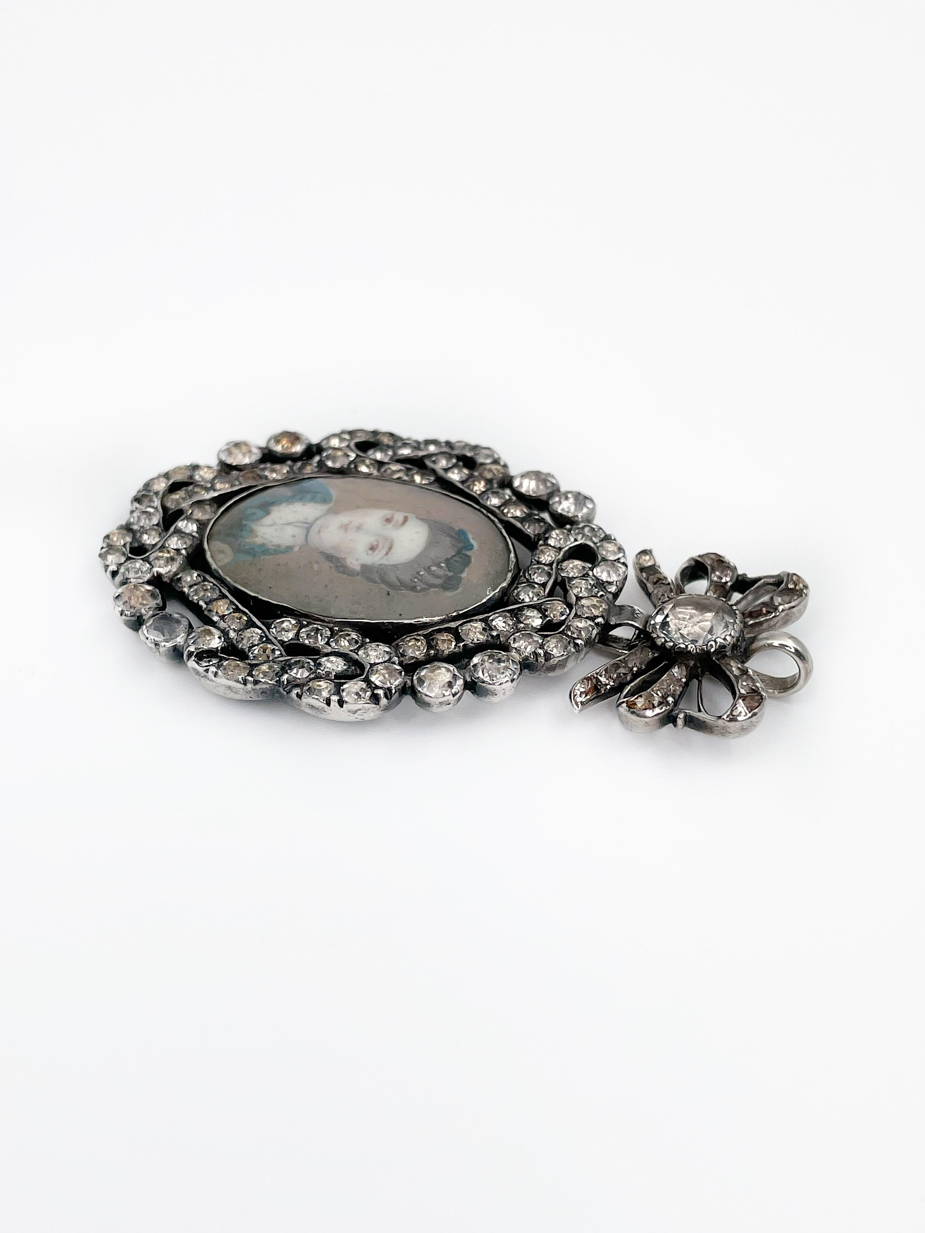 This miniature portrait pendant is an exceptional and collectable piece of jewelry dating from the late 18th century. 

It is crafted in metal and is set with giardinetti paste, which is rare and saught after. The crystals vary slightly in color and