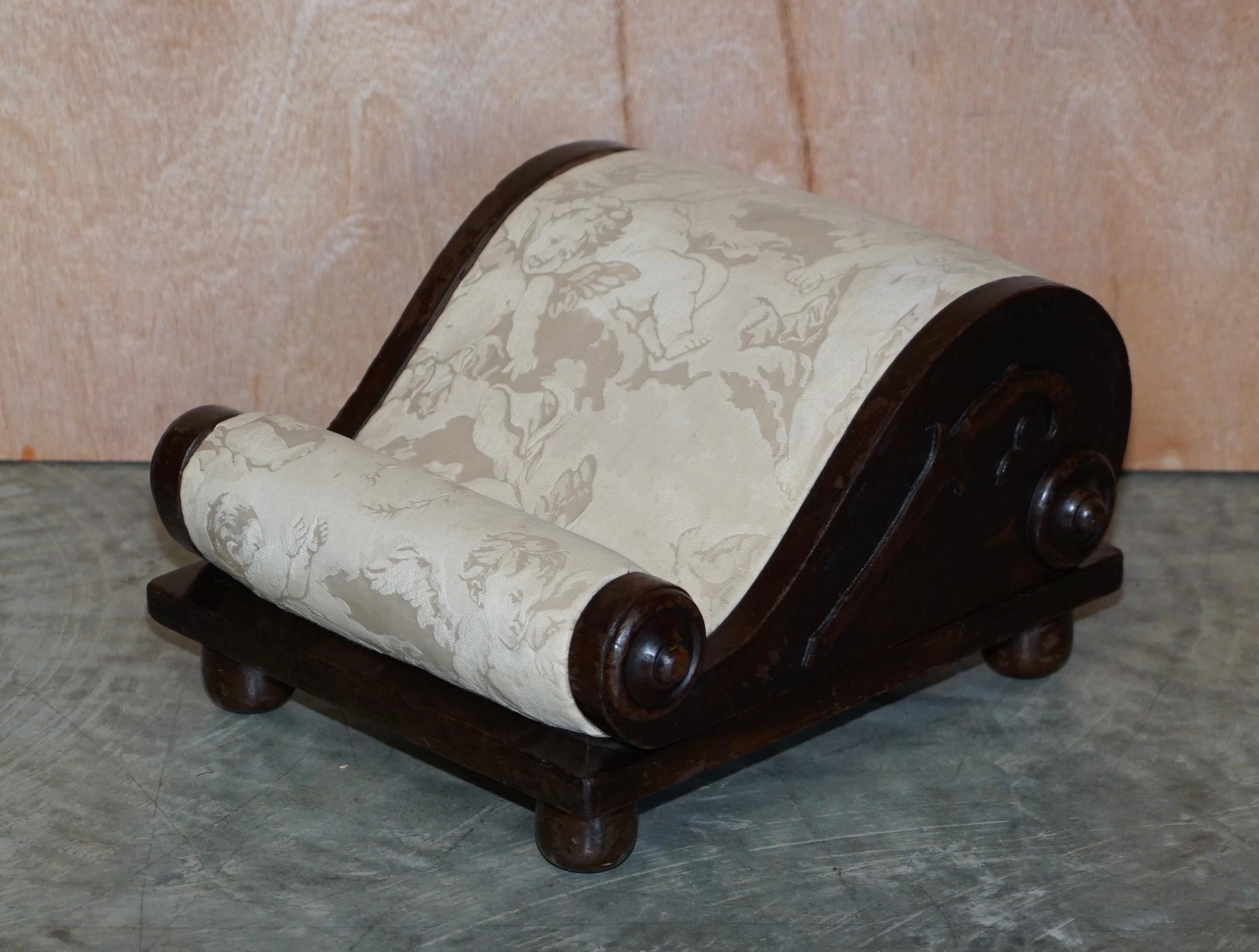 We are delighted to offer for sale this stunning original Georgian circa 1800 scroll footstool with Cherub upholstery

What a find! This has to be the most sculptural and ornate little footstool I have ever seen, the lines are amazing from every