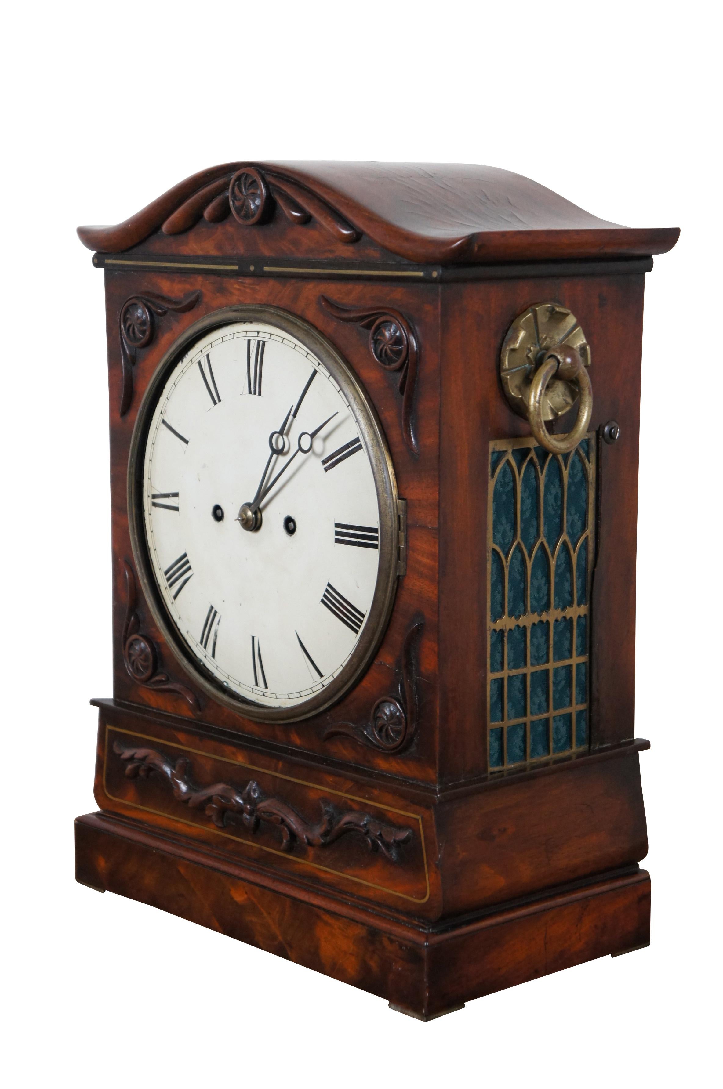Antique 19th century Georgian, key wind, double / twin fusee bracket clock with pull chime cord. Flame mahogany case with oxbow top and carved pinwheels and scrolls. Sides feature brass rind handles over cathedral window panels backed with deep teal