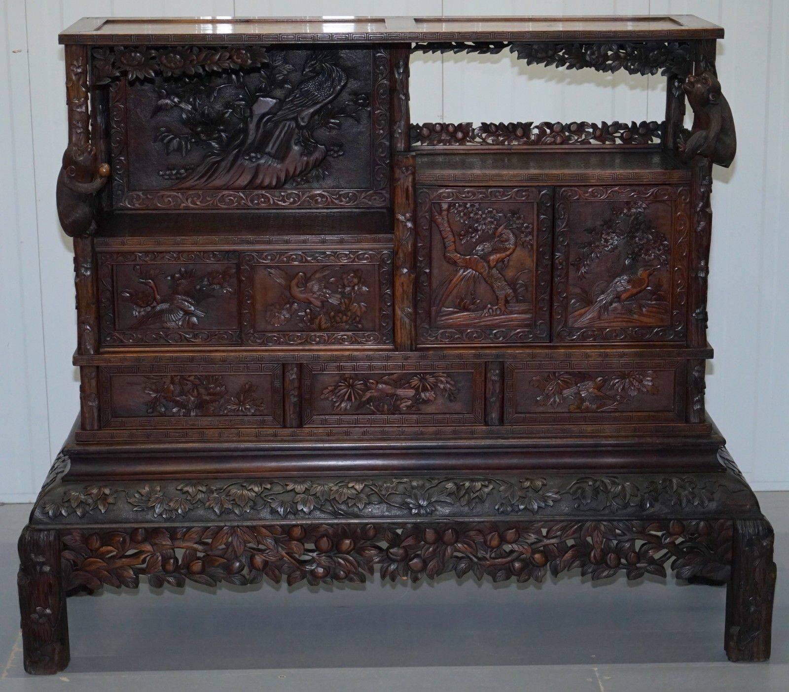 We are delighted to offer for sale this absolutely stunning hand-carved Chinese cabinet with drawers depicting bird’s, flowers and large monkeys 

A truly stunning find, the plinth base separates into two sections, the first is almost completely