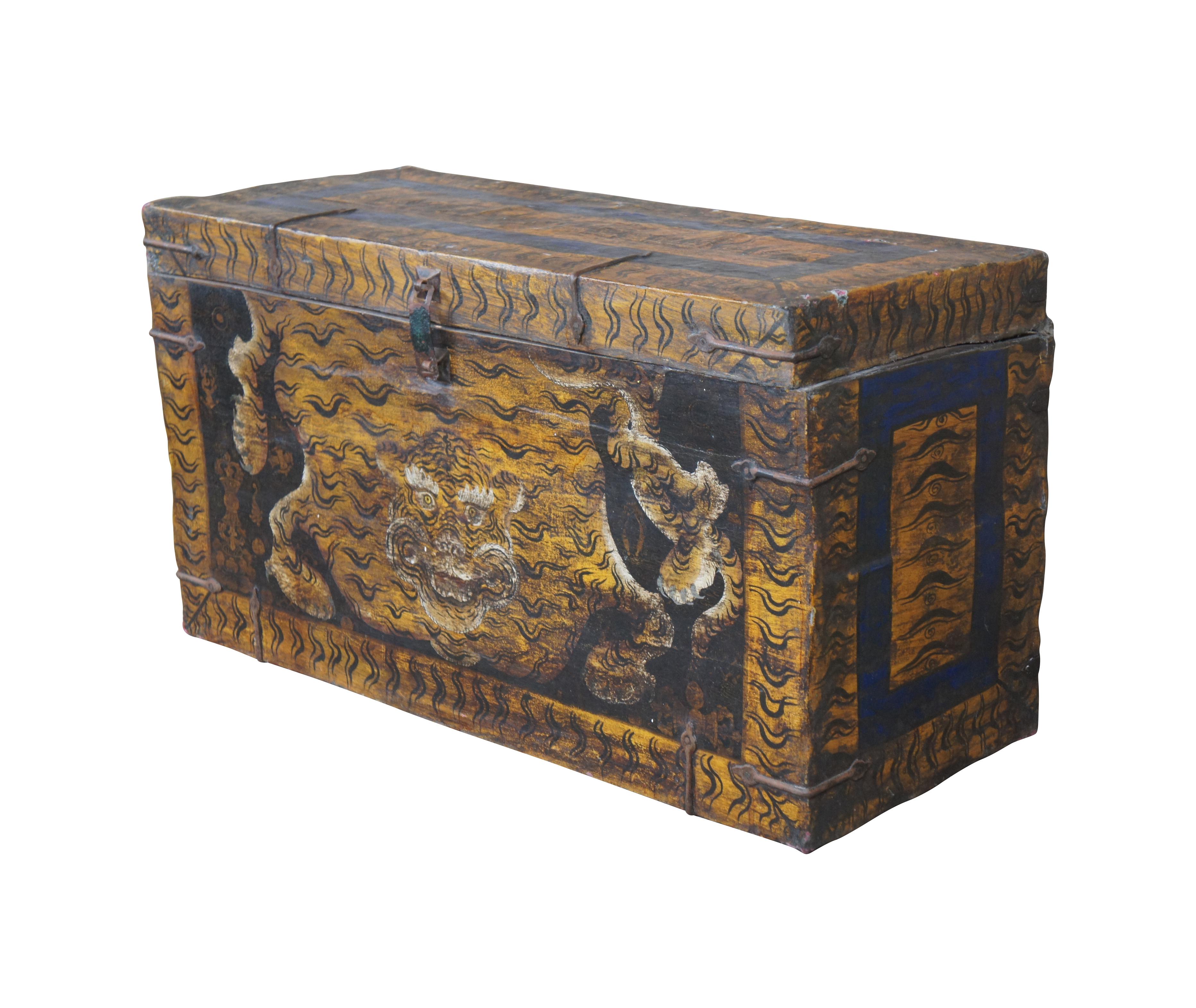 An impressive Tibetan storage from the first quarter of the 20th century. A wooden frame richly finished with lacquered leather hide and banded iron hardware. The front is hand-painted with a tiger at the center and framed in tiger stripes. The