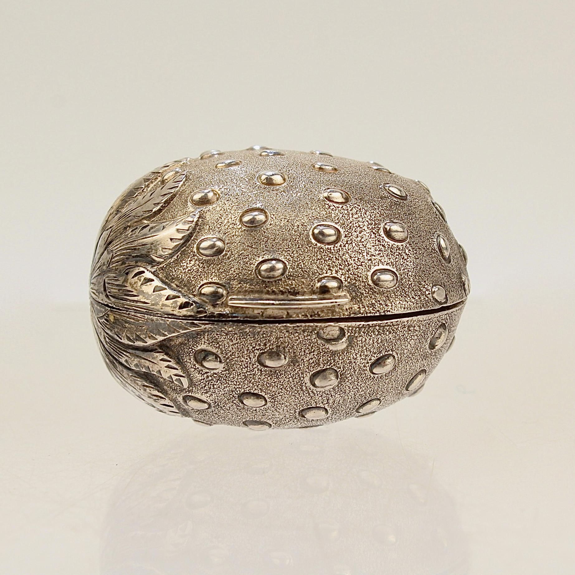 An extraordinarily rare English sterling silver nutmeg grater.

In the form of a strawberry by Hilliard and Thomason of Birmingham, England.

Modeled as a strawberry formed body, it has a semi-matte finished surface with raised 'seeds' and 'leaves'.