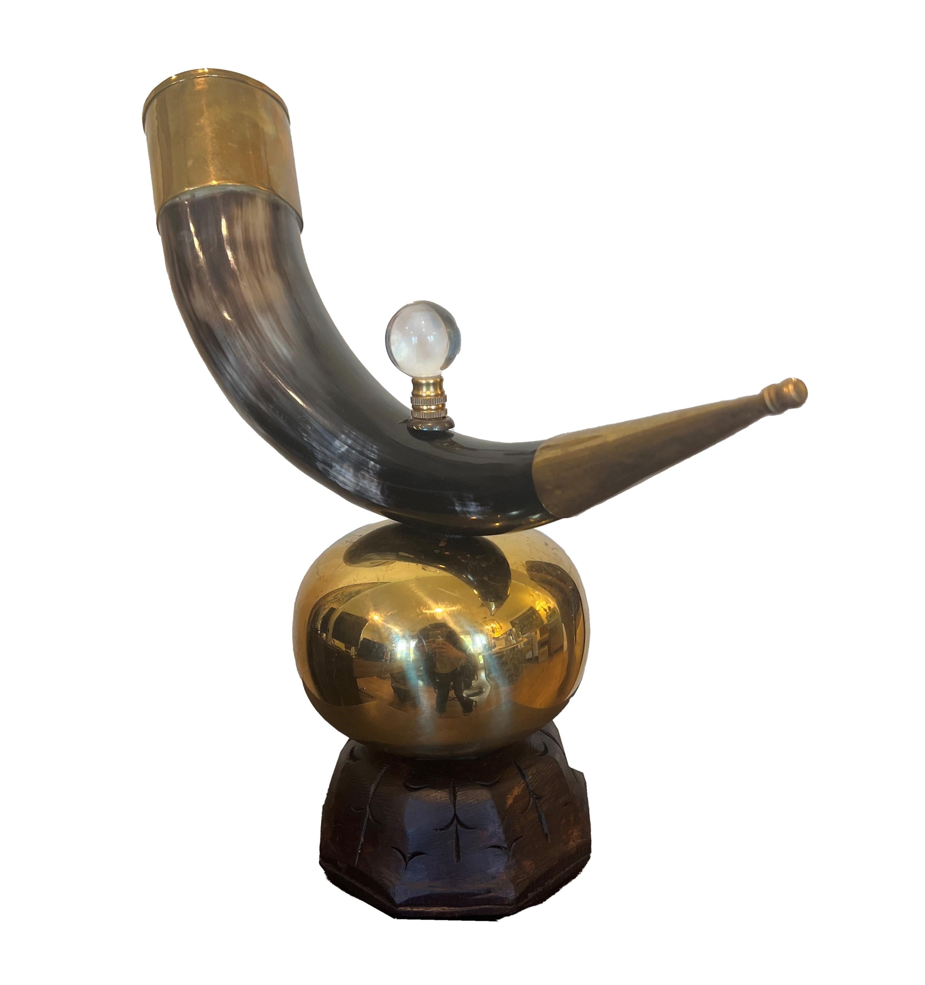 A rare antique horn, a unique and intriguing accessory that promises to elevate the sophistication of any space it graces. Mounted on an elegant brass stand that beautifully complements its natural allure, the horn boasts a patina that only time can