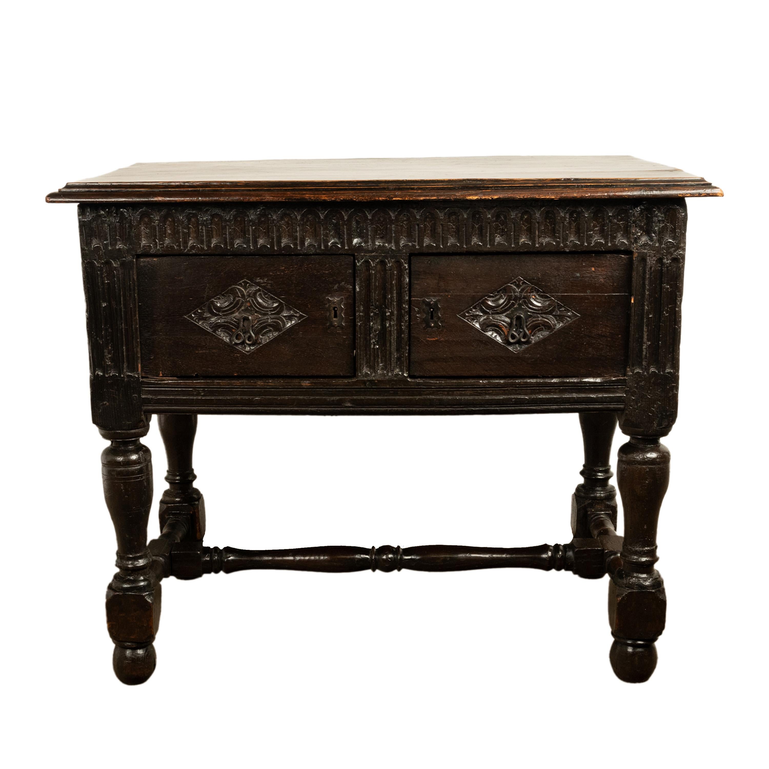 A rare antique King James I period carved oak side table, sideboard, cupboard, circa 1620.
This rare & diminutive Jacobean joined sideboard/table having a carved arcaded gallery on the front and to each side, below is a pair of cupboard doors with