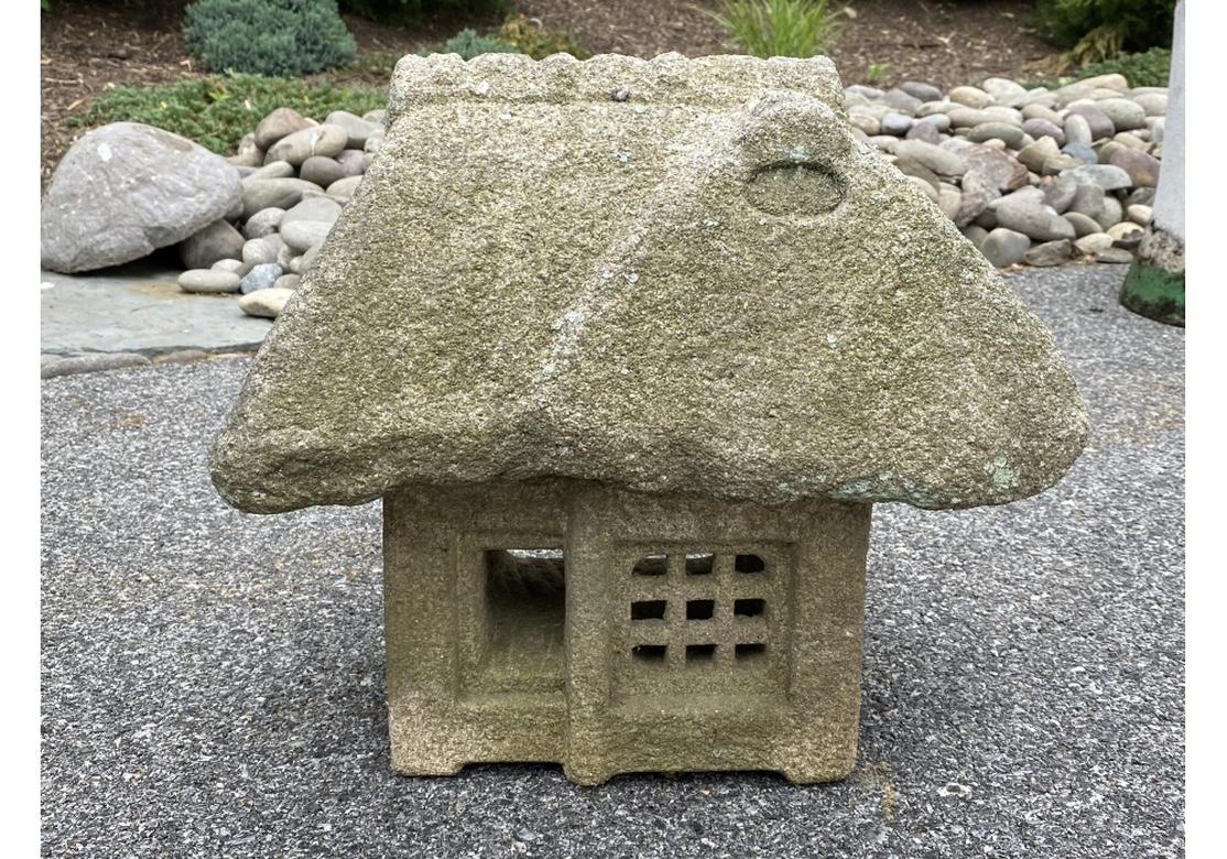 Rare and complete Antique Japanese carved stone architectural model of a traditional Folk Cottage. Having a doorway and grid window at the front and an open back. The roof is one carved stone and has age borne weathering and lichen spots with the