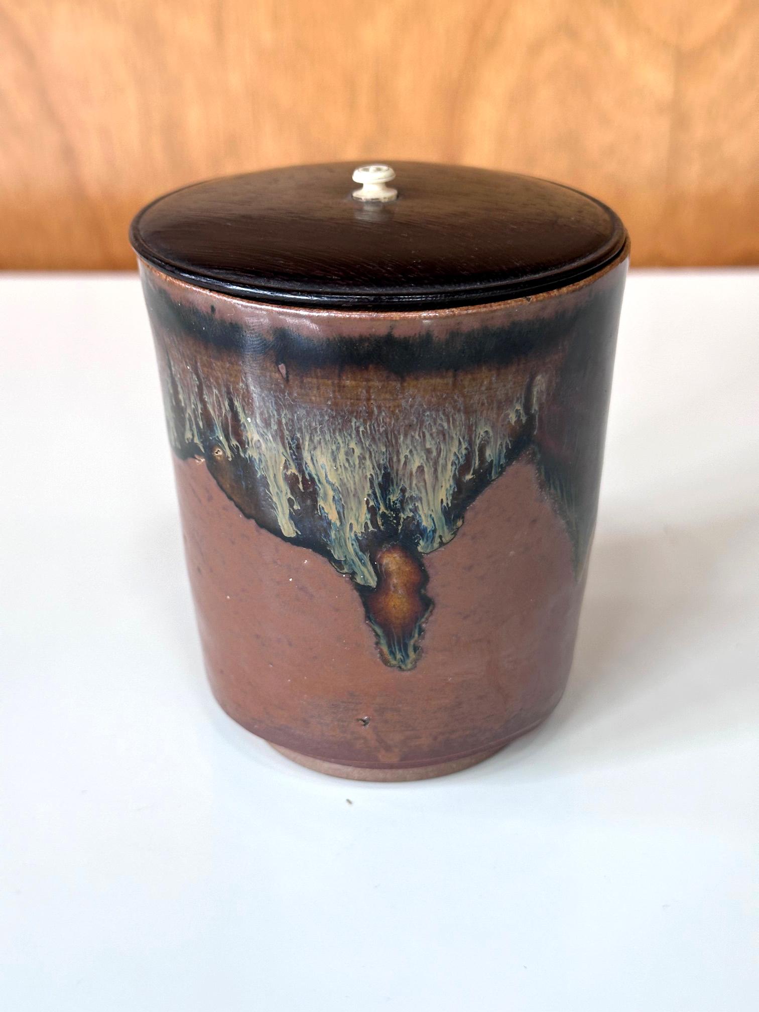 This small ceramic container from Edo period Japan circa 1800s was made in the Takatori Kilns in Fukuoka Prefecture. This type of small, tall jar with a lid was specifically created as a Hoso Mizusashi (slender freshwater container) for tea ceremony