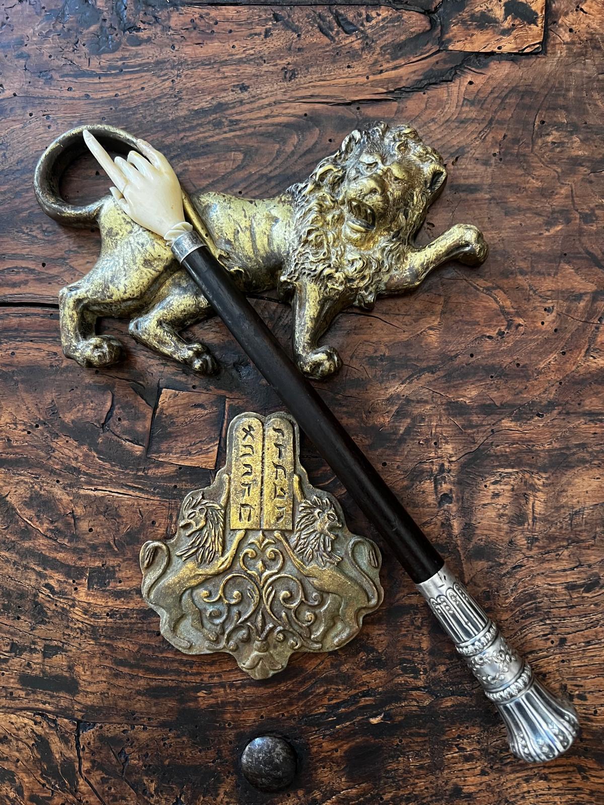 This very unusual Torah Pointer originated from Germany. The index finger has been professionally restored. The Pointer is complemented by ornamented sterling silver end. 
This Yad is exceptional and very rare. It survived WW2 and the dark times