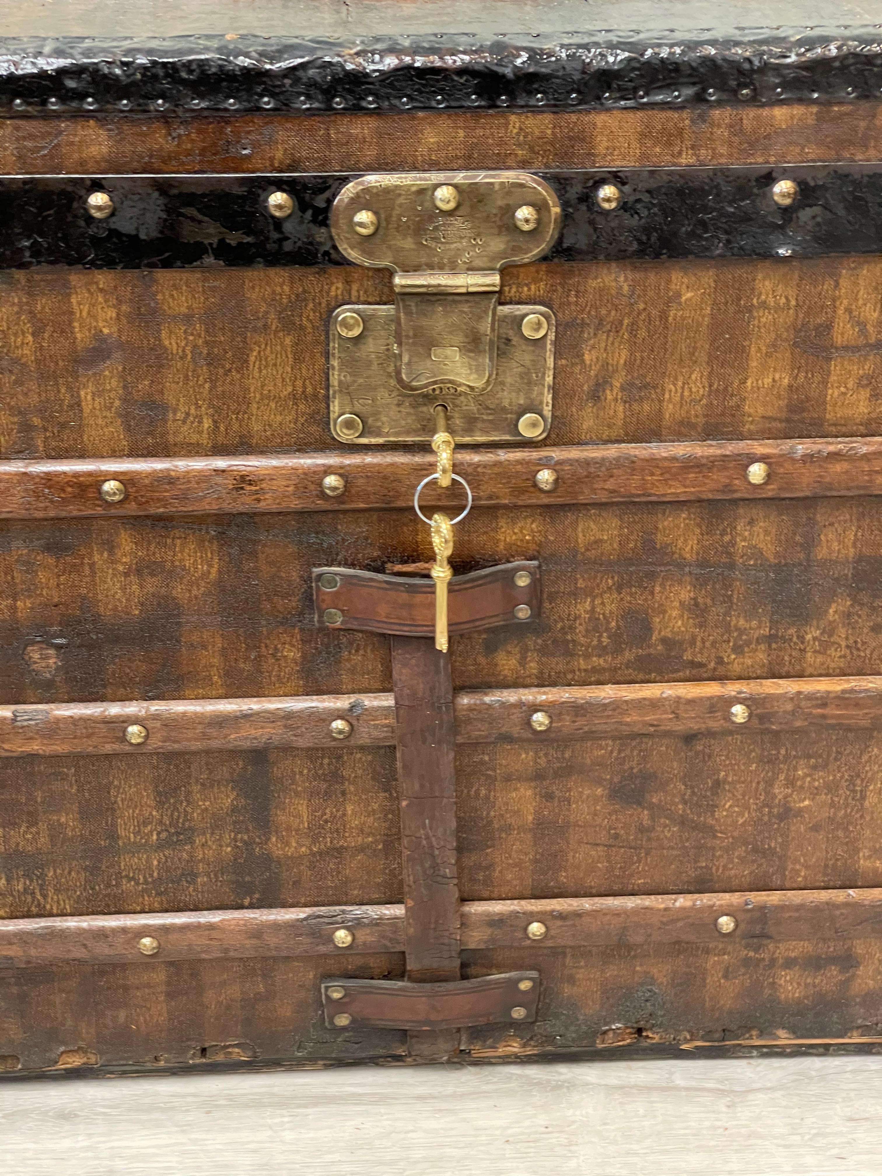 Rare antique Louis Vuitton striped shipping trunk, late 19th century; Louis Vuitton lock plate serial No. 10535, with Paris rue Scribe Address and London Oxford Street Address; bronze and metal hardware, iron handles, metal bottom. Original Louis