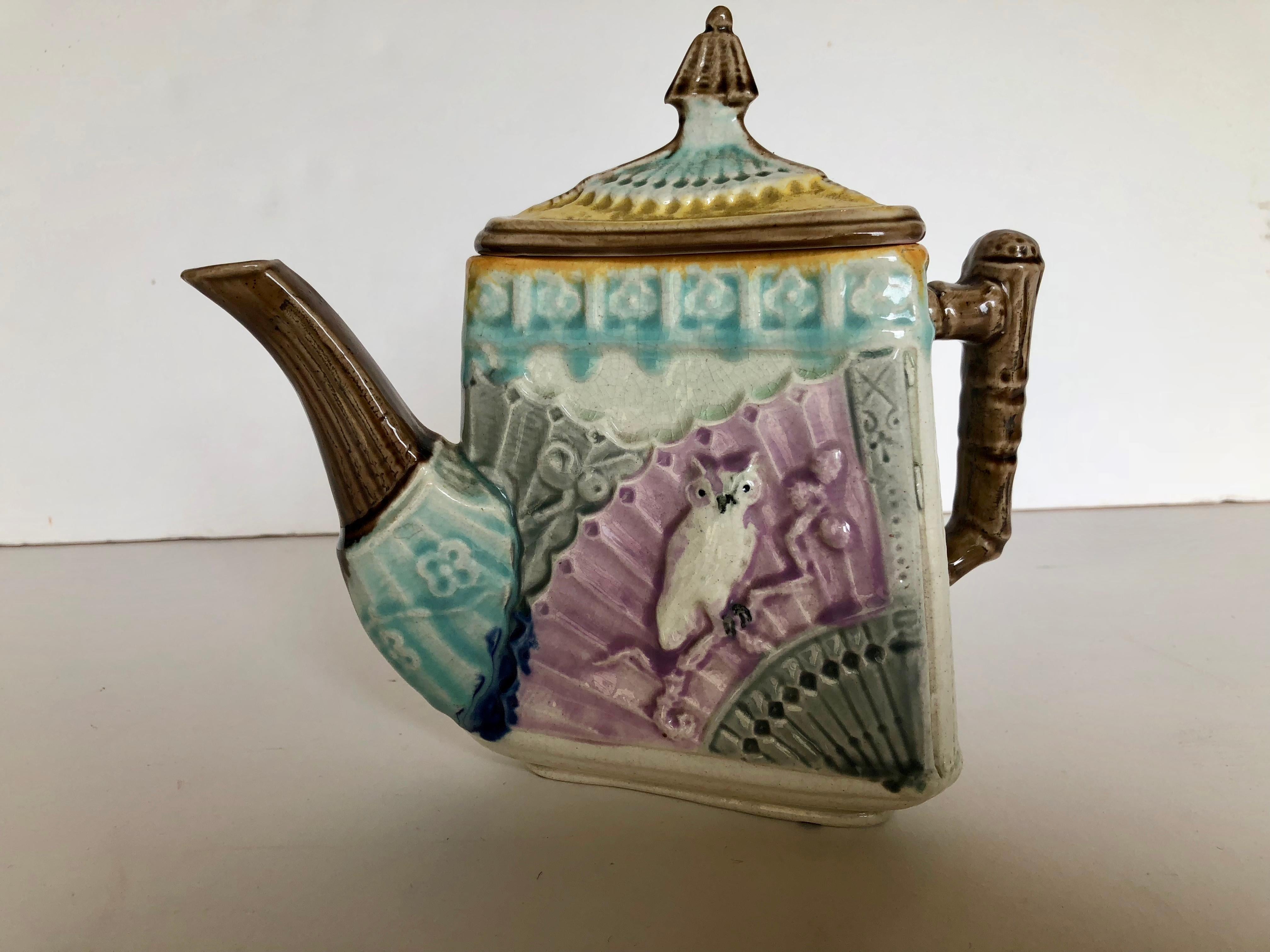 Rare, antique Majolica triangular owl and fan teapot, circa 1885. Soft colors, yellow, turquoise, lavender, brown, dark royal blue, soft gray and off white. Inside is soft lavender/pink. Very good condition with minimal overall crazing typical of