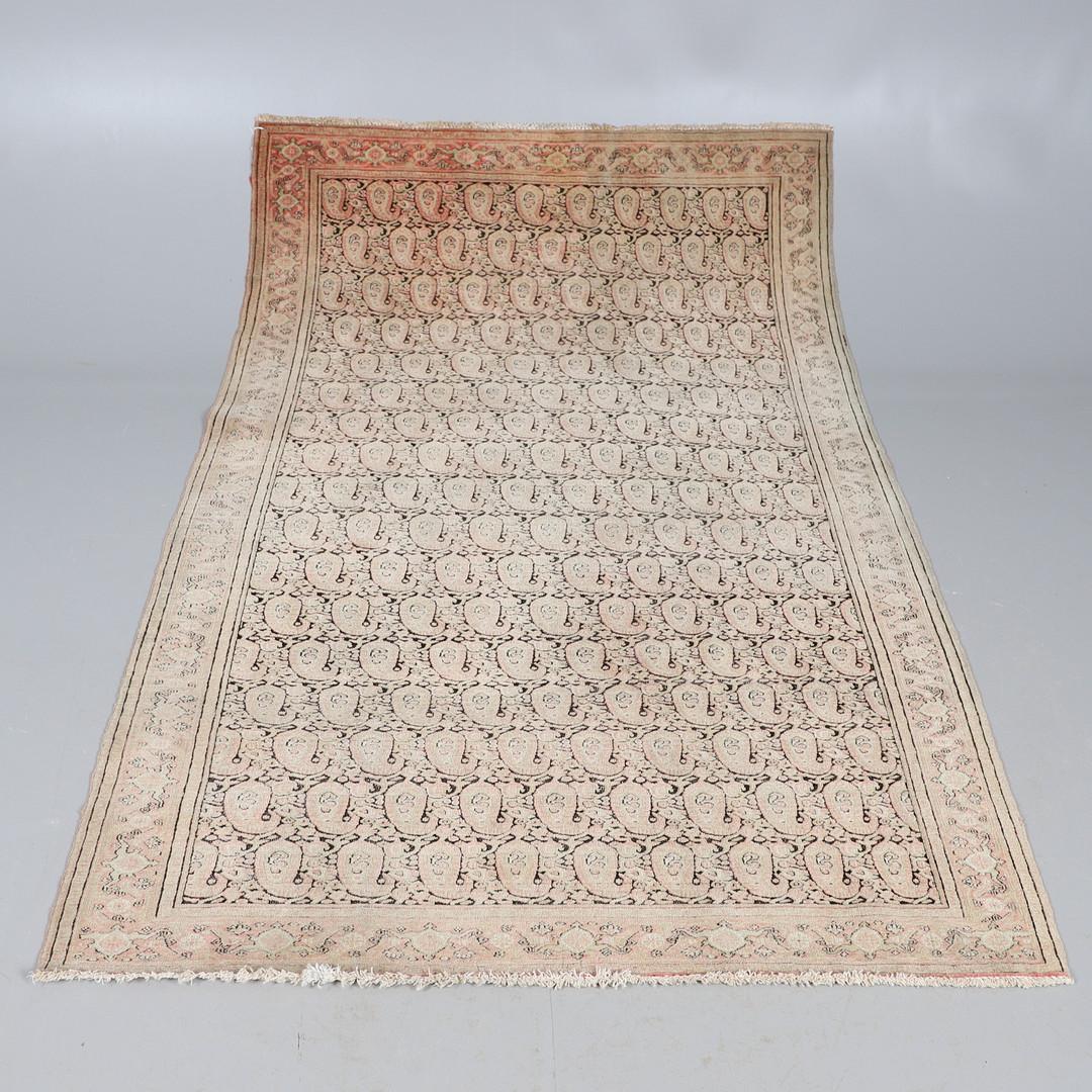 Blush Pink paisleys have been woven into a highly detailed design in this antique rug Caucasian area rug, handwoven in Azerbaijan in 1900. The Malayer rug features a stunning all-over design woven on a red background with a paisley pattern all over