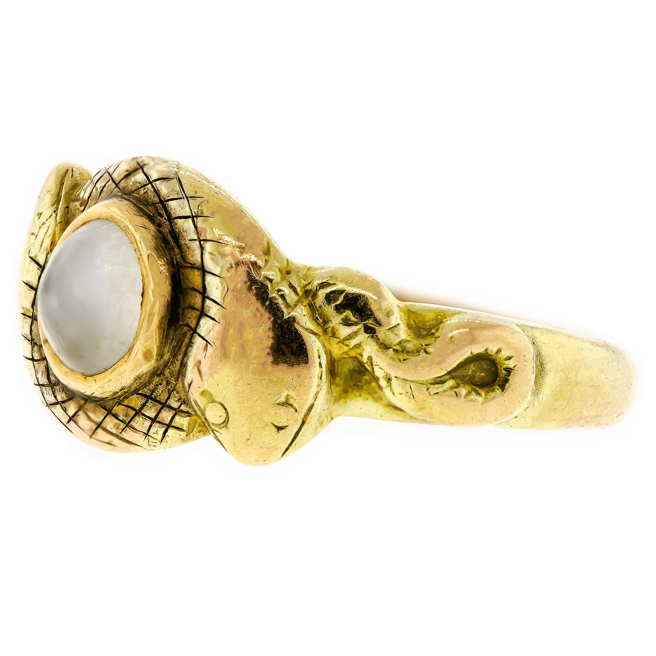 Rare antique moonstone double snake 14 karat yellow gold ring - centrally bezel set with one round moonstone - accented on the sides with two snakes coiled around each other - rendered in 14k yellow gold - currently about a size 7 3/4 but can be