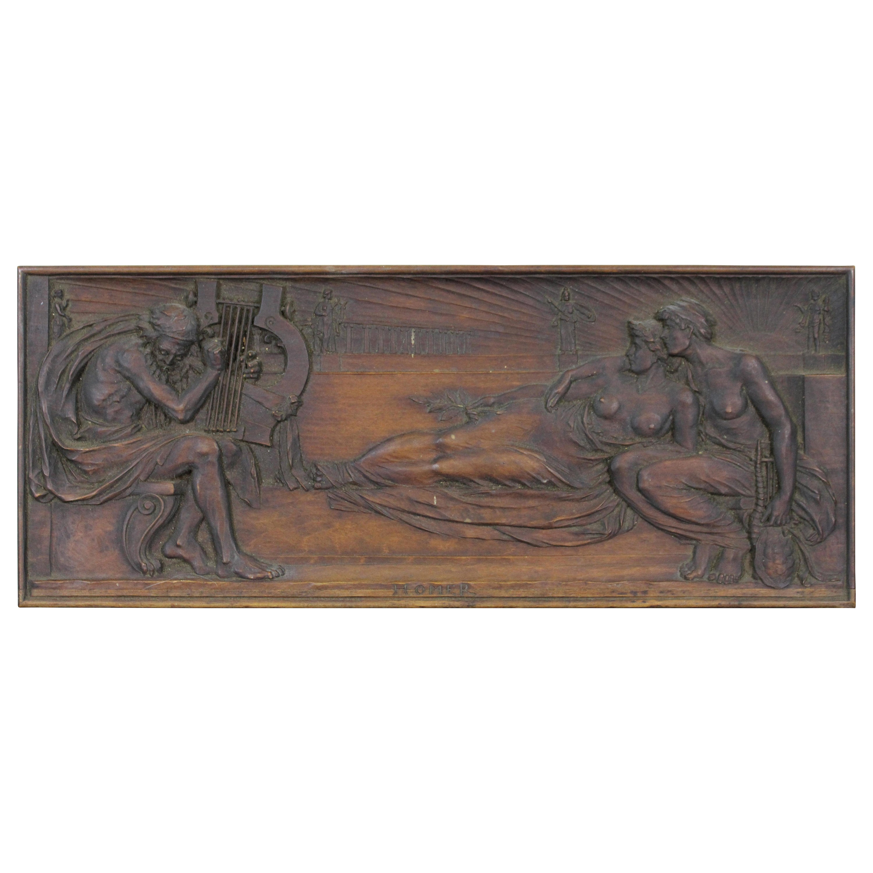 Rare antique carved wood reproduction of a clay relief sculpture by Harry Bates, depicting the Greek poet Homer, playing the lyre for two Muses. “The famed Greek epic poet Homer is said to have flourished around 700 B.C. Credited to him are the