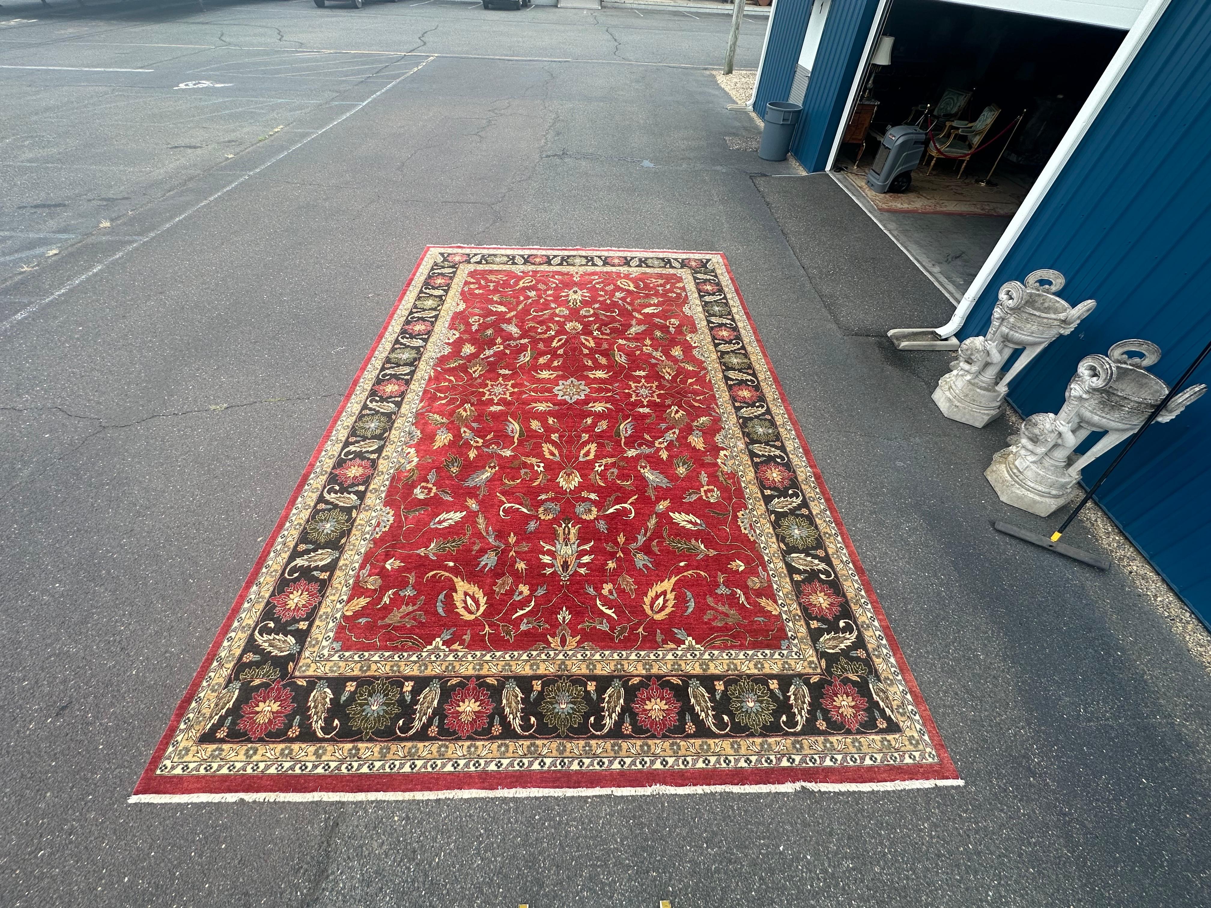 This is a phenomenal palace size 12 x 18 feet Oushak rug of Turkey. There are gorgeous jewel tones of yellows, peach, and emerald greens set on a vibrant red and navy field. The rug dates to the 1920s era and has some minor signs of age and wear but