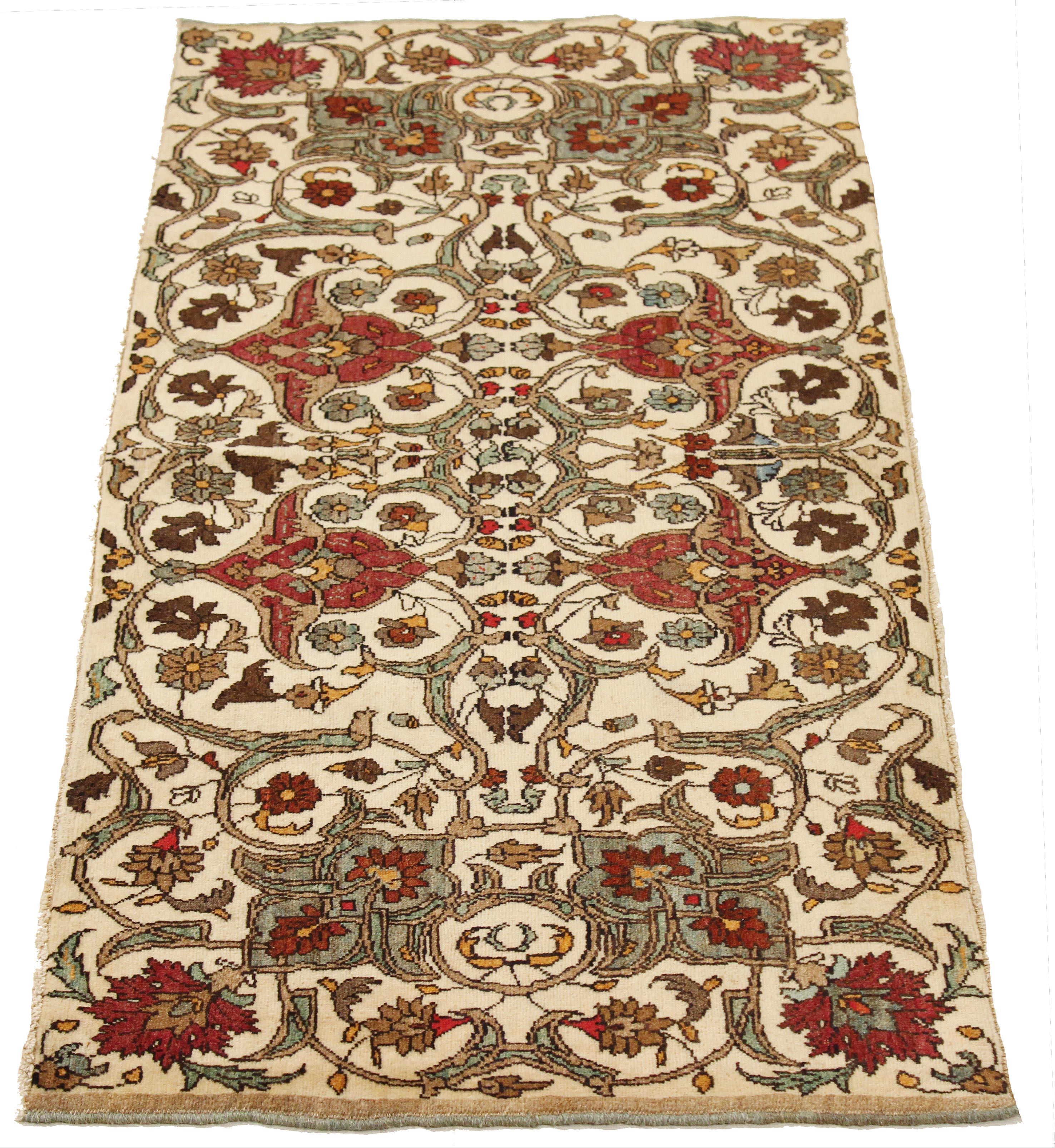 Rare antique Persian rug handwoven from the finest sheep’s wool and colored with all-natural vegetable dyes that are safe for humans and pets. It’s a traditional Semnan design featuring red and brown floral details over an ivory field. It’s a lovely