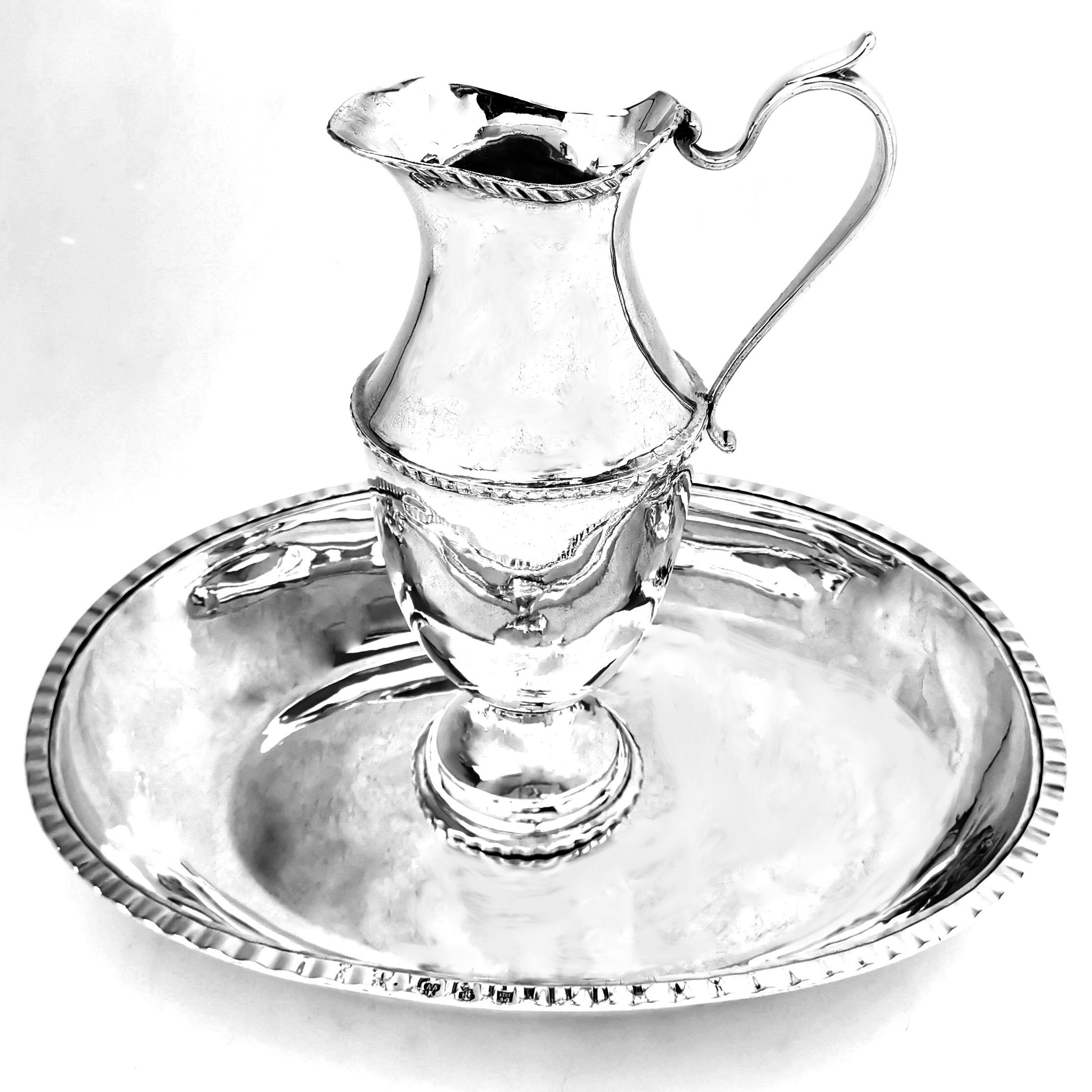 A magnificent antique Russian solid Silver Jug and Basin with an elegant polished silver finish. The bowl is a round cornered rectangle with a understated border on the rim that is mirrored on the Jug. This elegant pair could be used for serving as