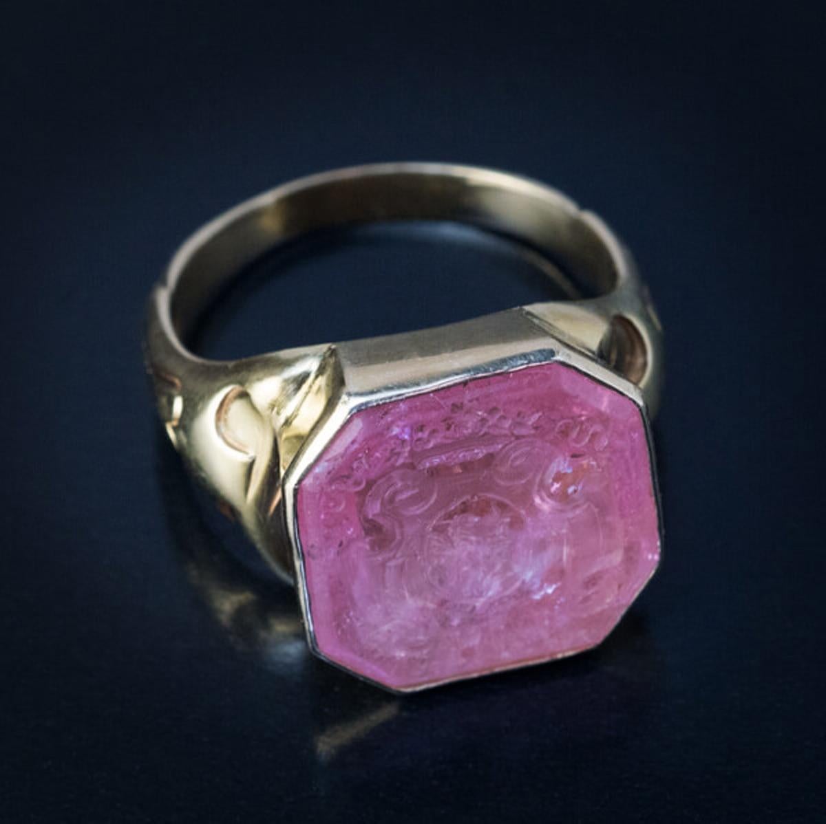 This rare antique Russian gold and carved pink tourmaline armorial signet ring is marked with St.Petersburg assay mark dated ‘1869’ but the tourmaline intaglio is much older. It dates to circa 1730. The intaglio is engraved with a griffin holding a