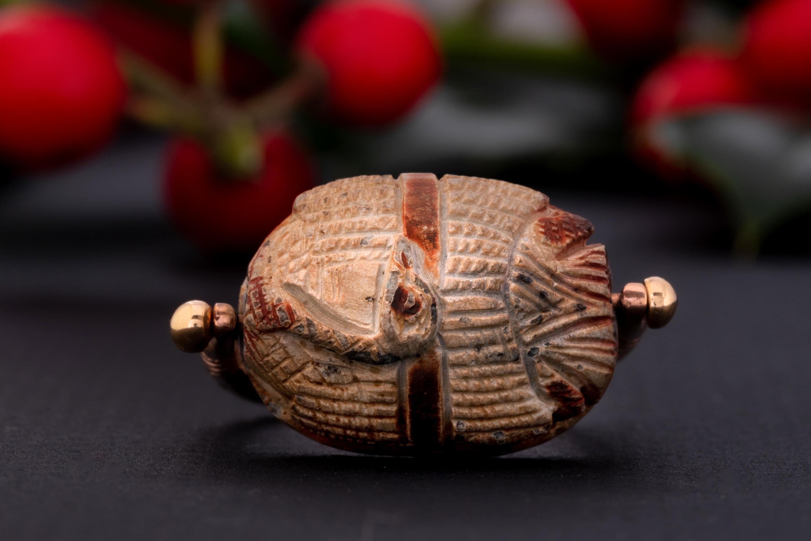 A rare Victorian scarab protection ring made is solid 9ct gold. 

This is a rare find for Egyptian jewelry which is set with a stone scarab swivel. The swivel has a carved duck body on its surface with the hieroglyphs on it`s back.

The swivel can