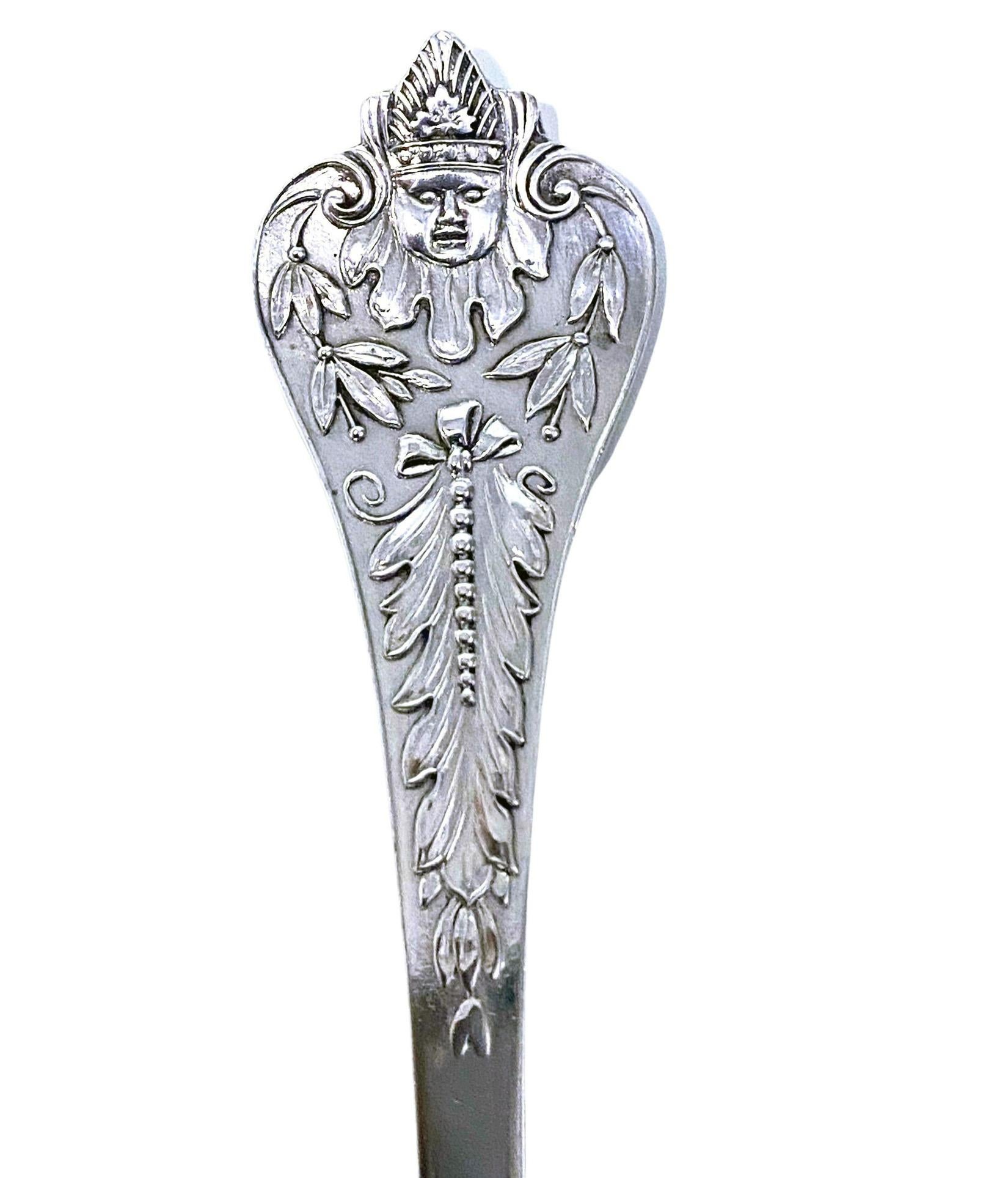Rare Antique silver figural head spoon, Birmingham 1910 Elkington. Beautifully decorated with figural handle with what appears to be a clown or merrymaker and foliate ribbon stem, partial gilded, scalloped fluted oval bowl. Length: 6.5 inches.