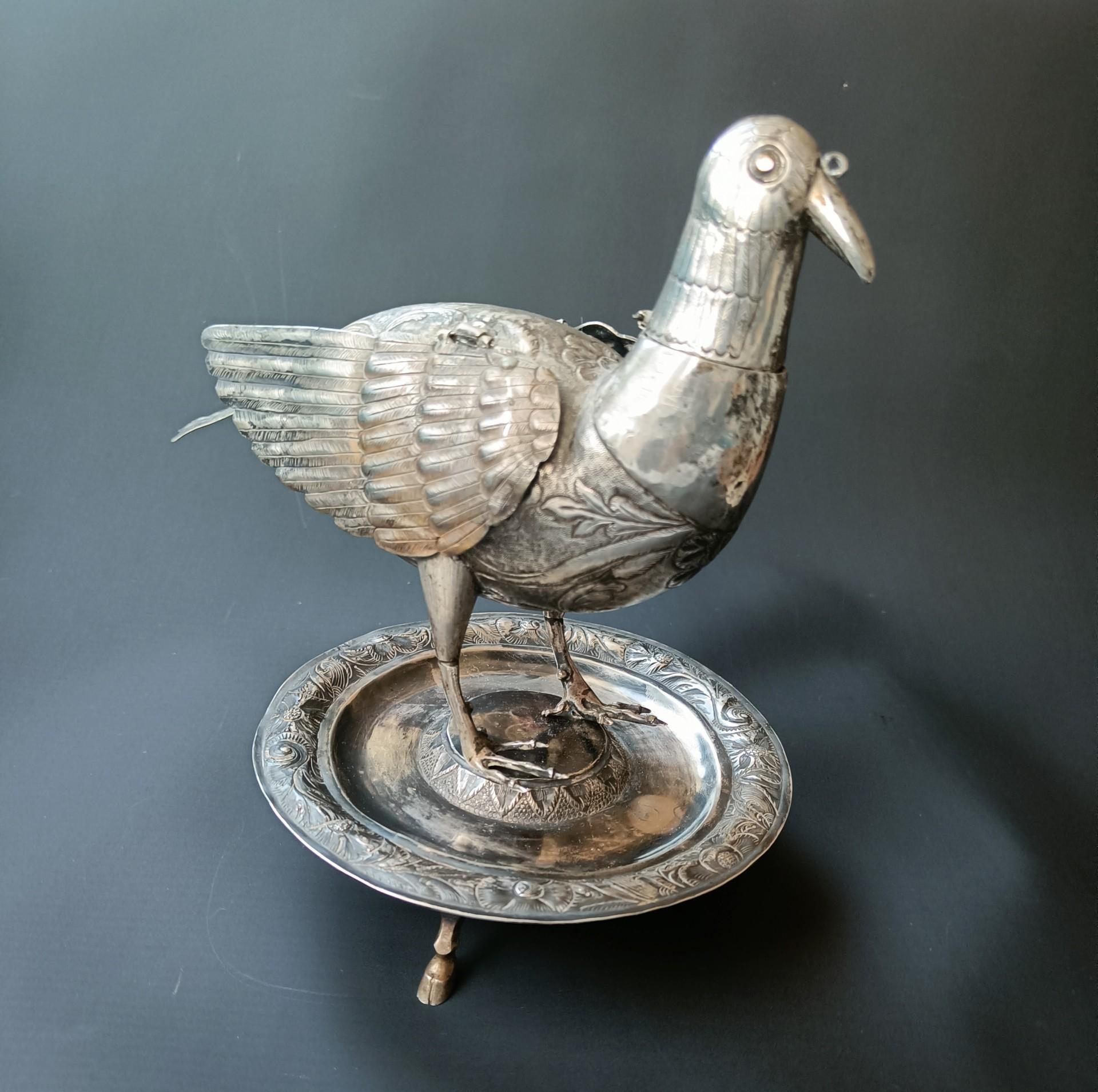 Fine rare Early Antique South American Colonial Silver Bird Vessel
A finely executed silver bird vessel raised on a circular base with reticulated head and wings with chased and repousse design's on the head body and wings, the eye of the bird with