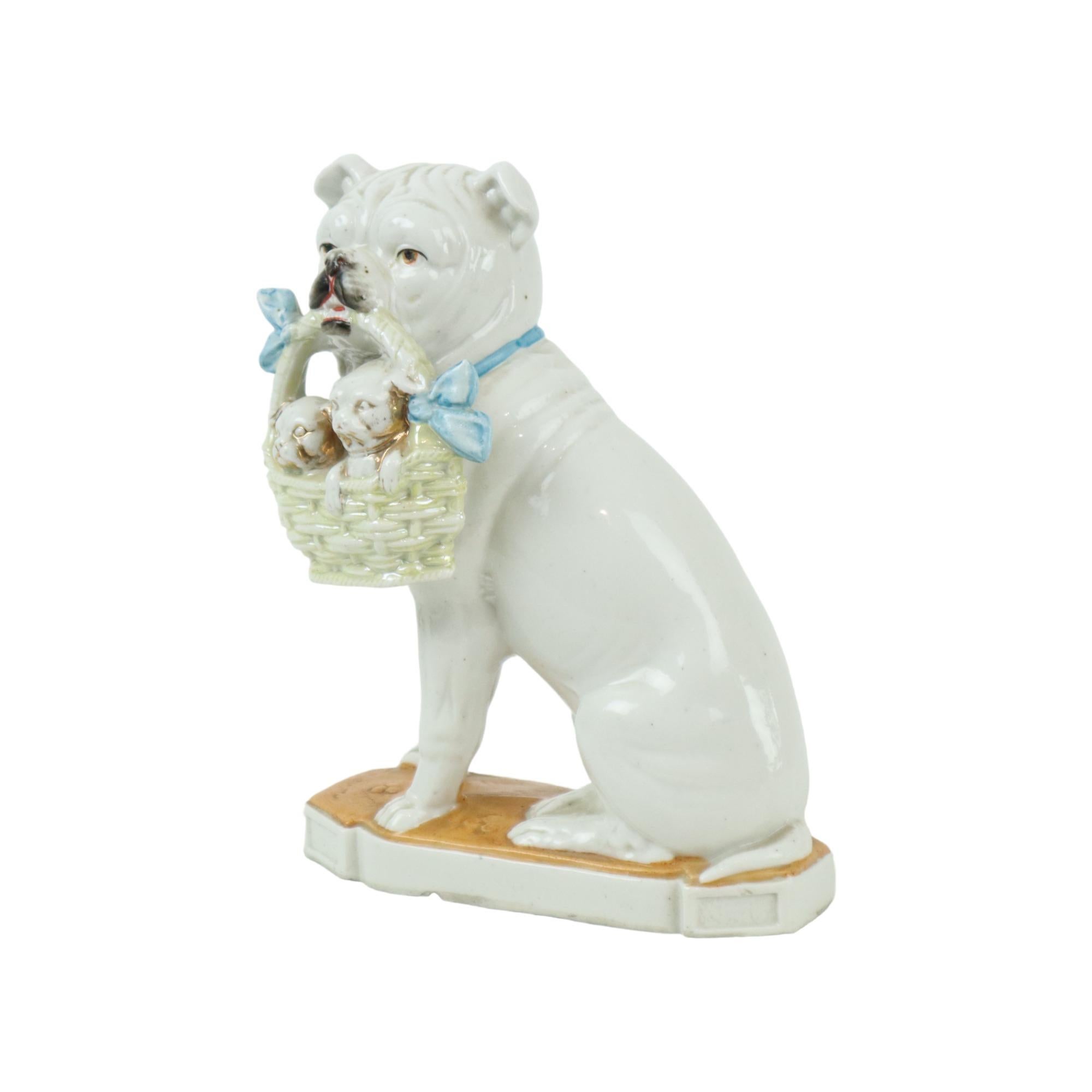 Beautiful rare antique statue, Art Nouveau figure of a bulldog or pug with a basket in its mouth with young puppies, numbered 3959 on the back, early 20th century.

Made of glazed porcelain, partly gilded, the basket has a light green color, finely