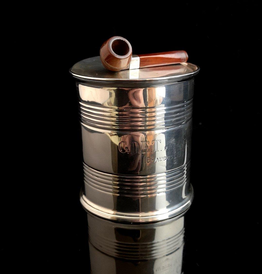 A very rare, novelty, antique sterling silver tobacco tin or box.

It has been designed as an empty can, very realistically detailed and similar in size to a regular food can.

It has a lift off lid, also in sterling silver with a miniature phenolic