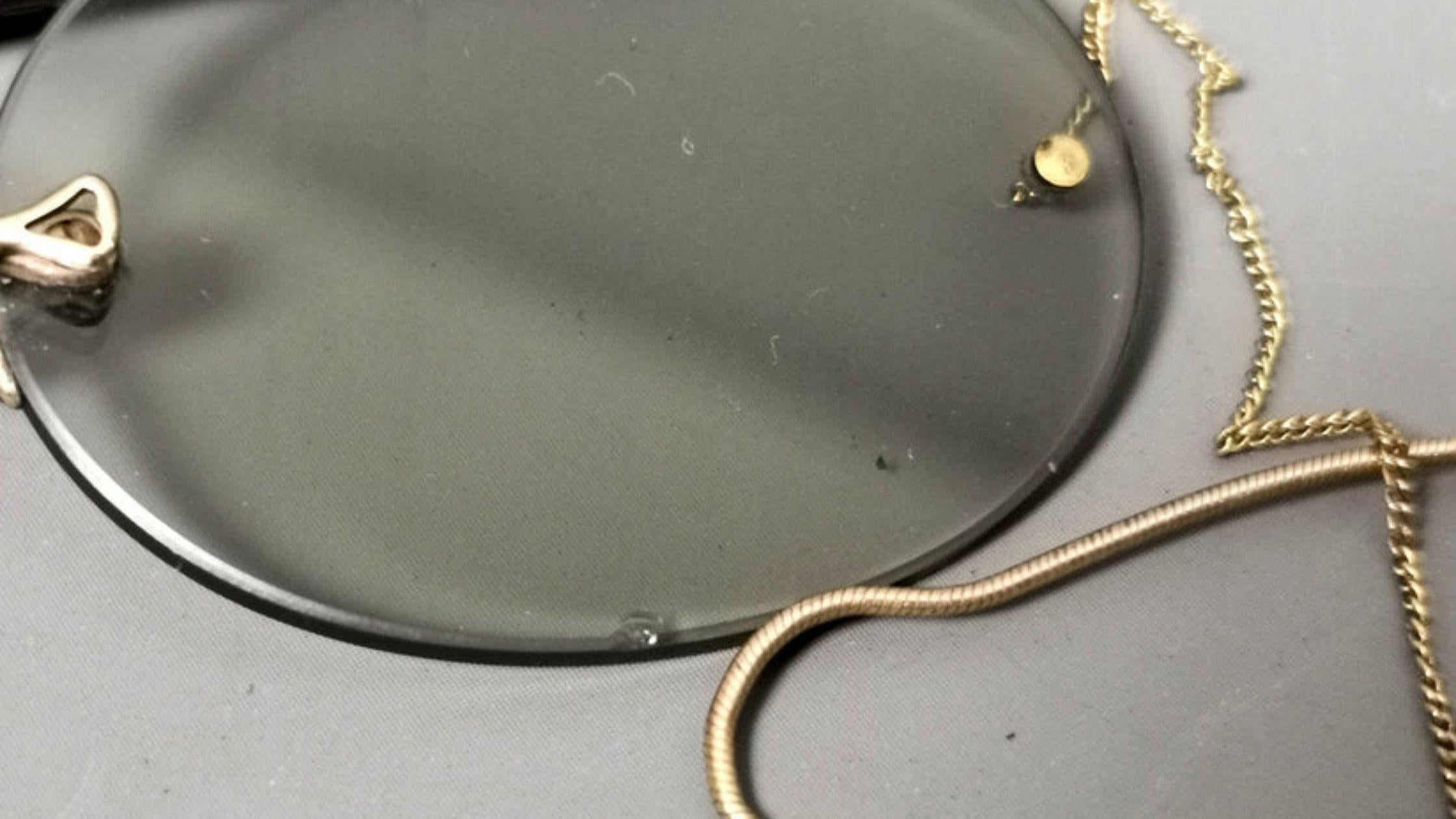 Man Takes a Pair of Pince-nez Glasses from a Small Case, Tries on Them