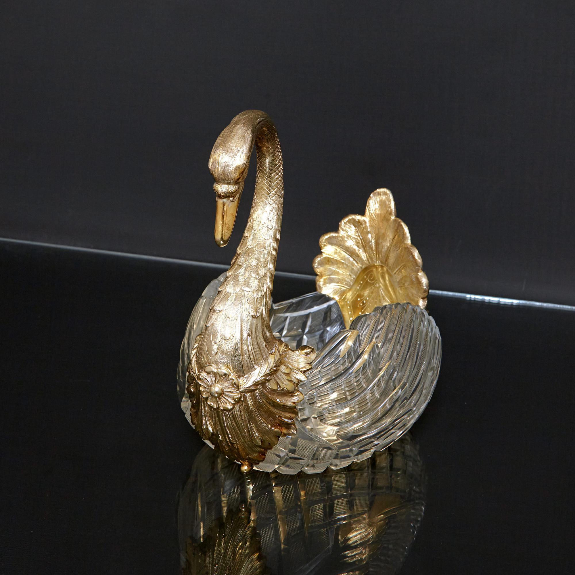 An unusual and attractive antique cut crystal bowl in the form of a swan. The body is formed from a cut-glass bowl and has gilded silver mounts that are realistically modelled as a swan's neck and tail. These sections have further decoration of