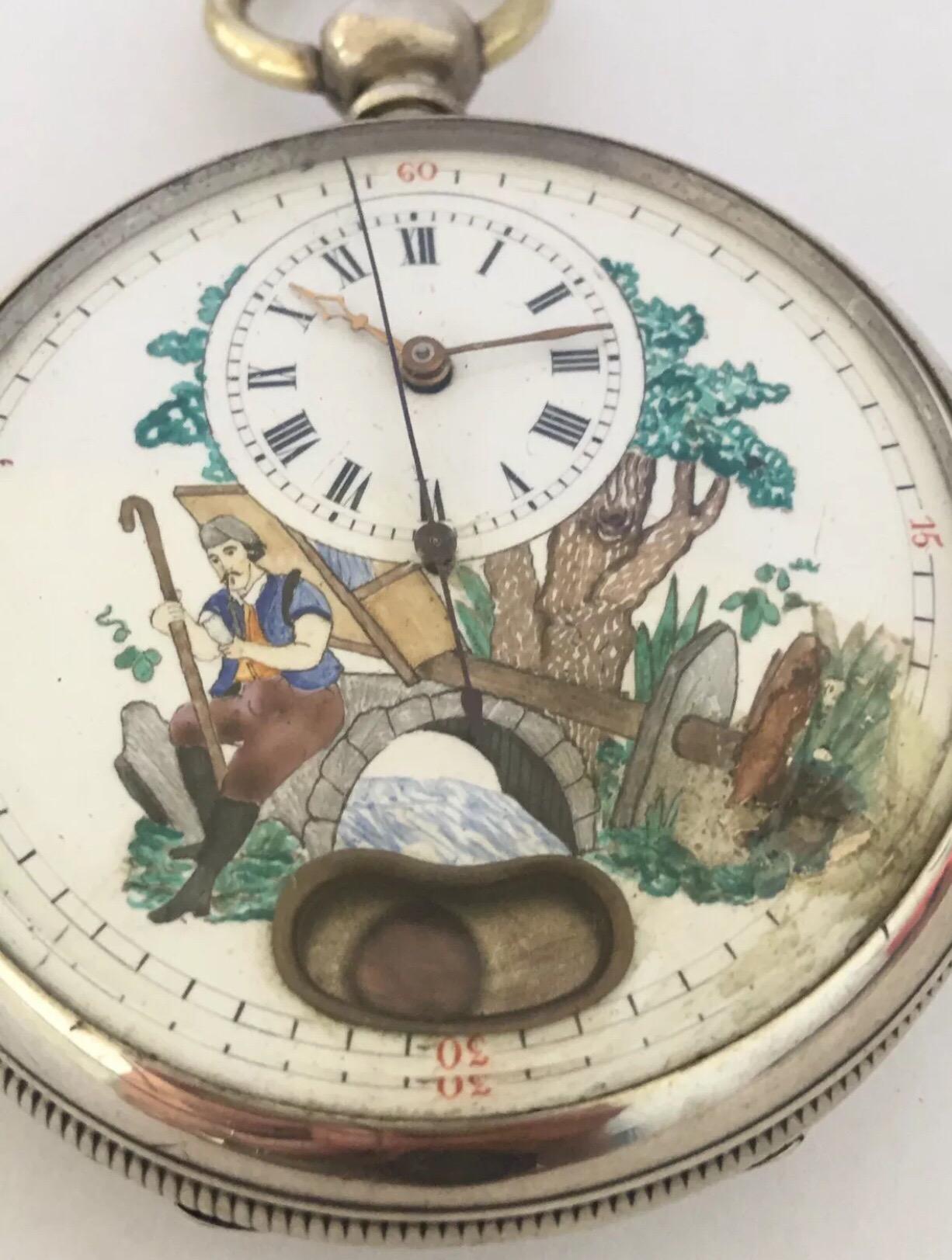 A very beautifully swiss made silver pocket watch. This late 19th century swiss silver pocket watch has a swift second hand and a mock pendulum aperture with a lovely hand painted enamel dial of a man in the country side. the watch has a spring