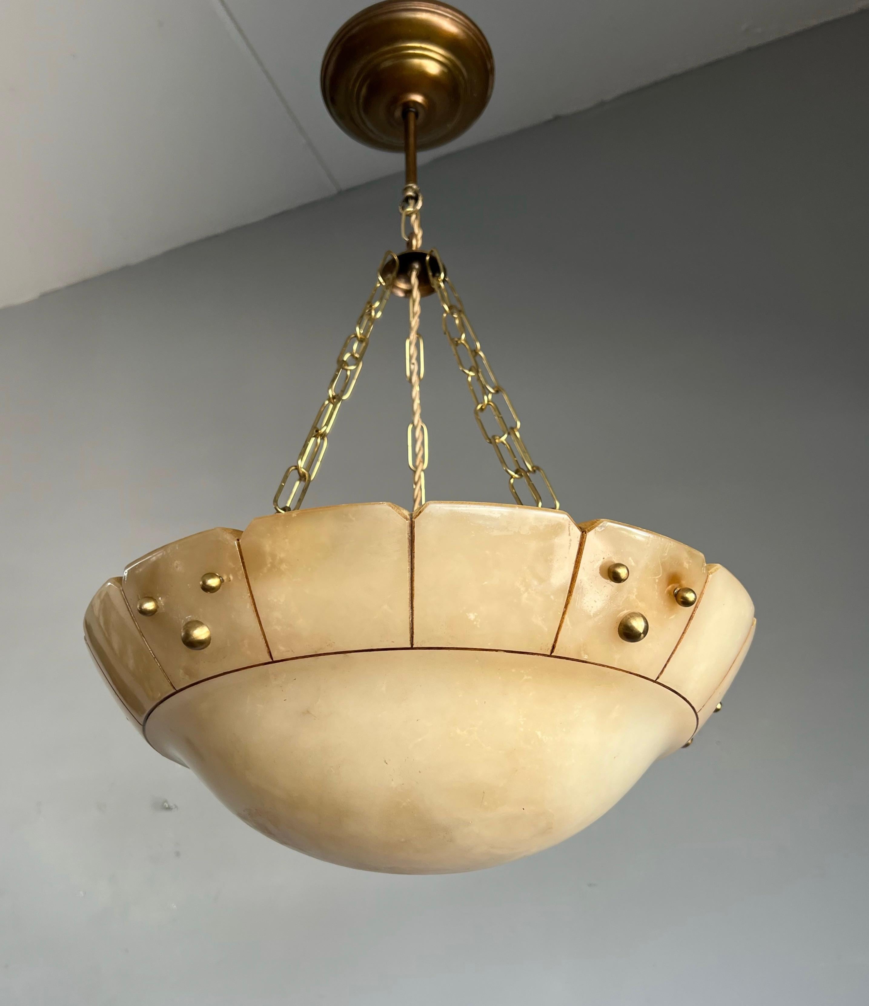 Stunning design and warm color alabaster and brass light fixture.

This timeless and ideal size antique pendant from the early 1900s is an absolute joy to come home to. The beautifully rounded, deep and rare color beige alabaster bowl has various