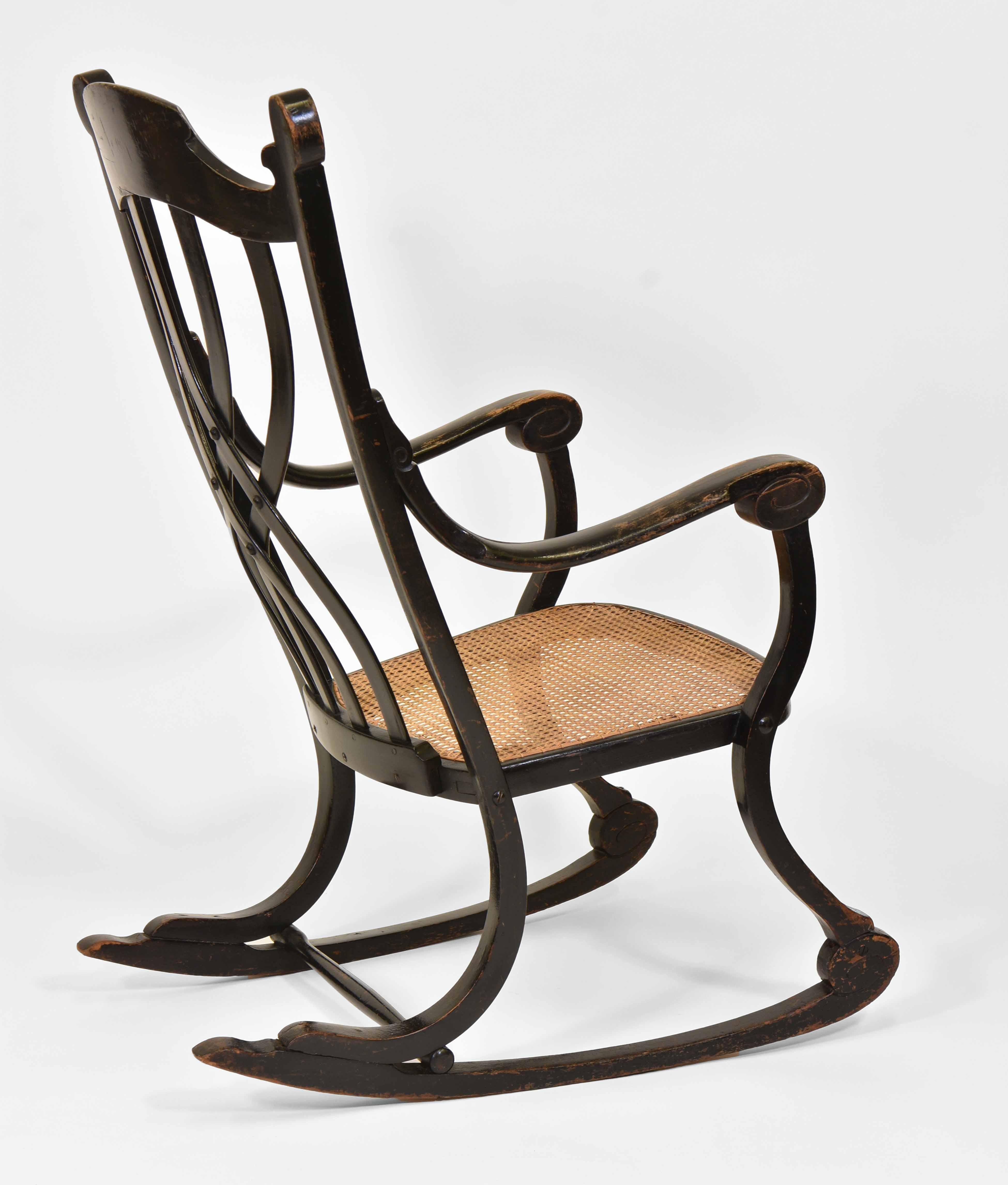 Rare Art Nouveau period Thonet swing chair, model 7401. Circa 1905. Faint stamp - Thonet Austria. 

The chair was probably blackened at some point, and considering the wear on the finish it would have been done a long time ago. The cane seat has