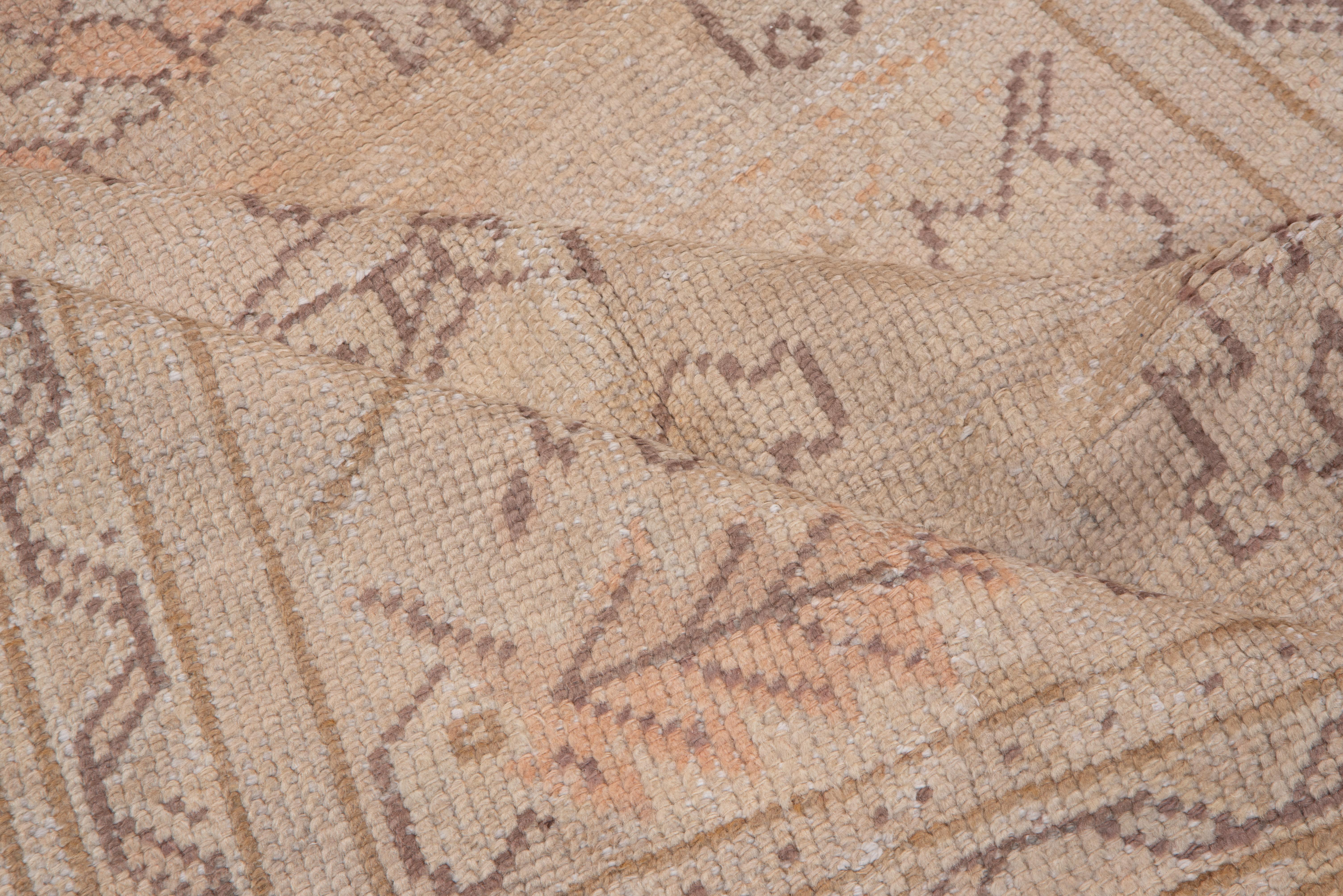 This light, tone-on-tone large West Anatolian workshop scatter shows an asymmetric design of large palmettes and sharply serrated leaves, on a sandy straw ground, accented in dark brown outlines. Coarse weave. Decorative, versatile look. Nice coral