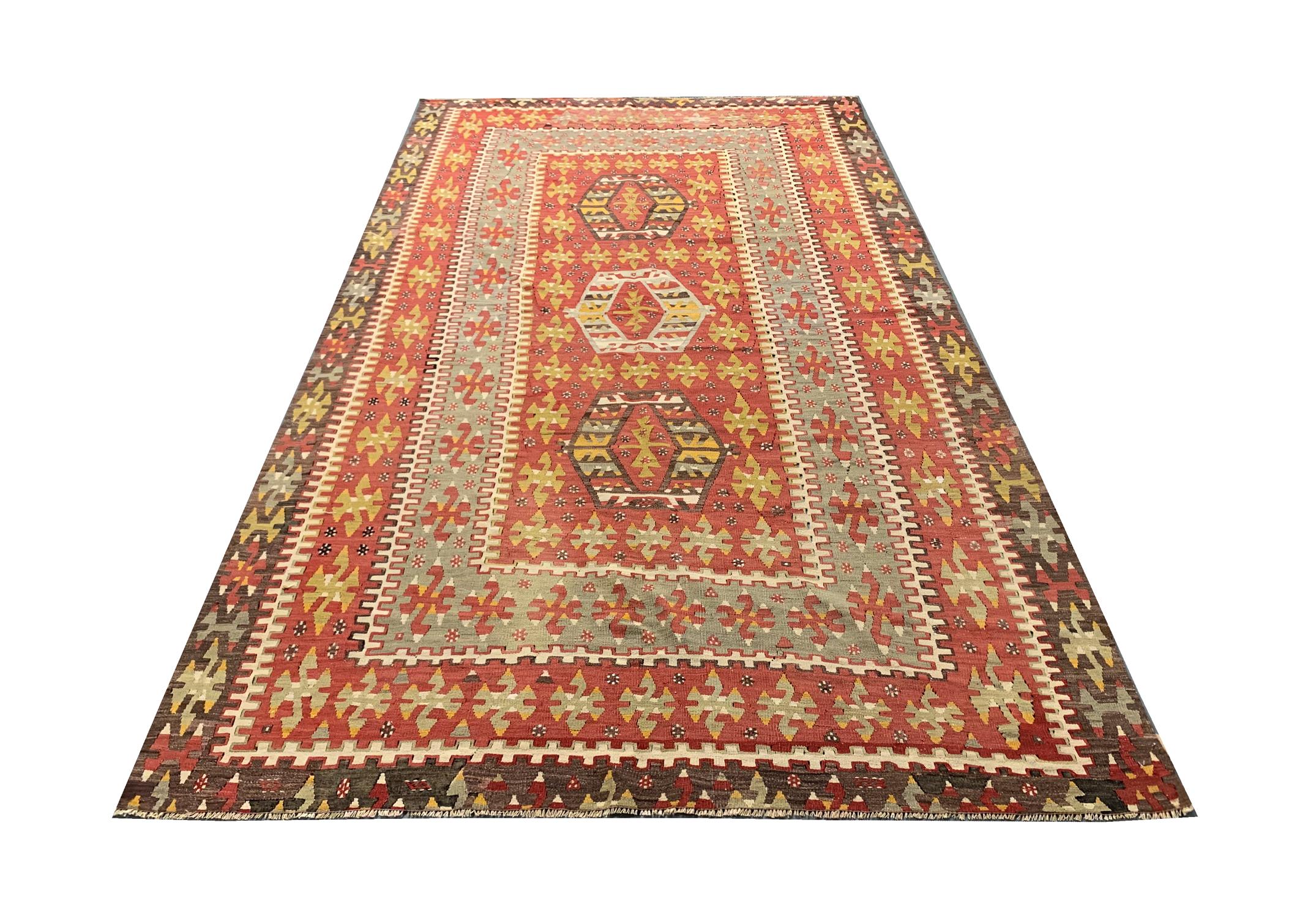 This fantastic Kilim was woven in the 20th Century and features a beautiful tribal design. Decorated with motifs and medallions woven intricately into this piece, it will make the perfect accent rug in any room. Guaranteed to uplift both modern and