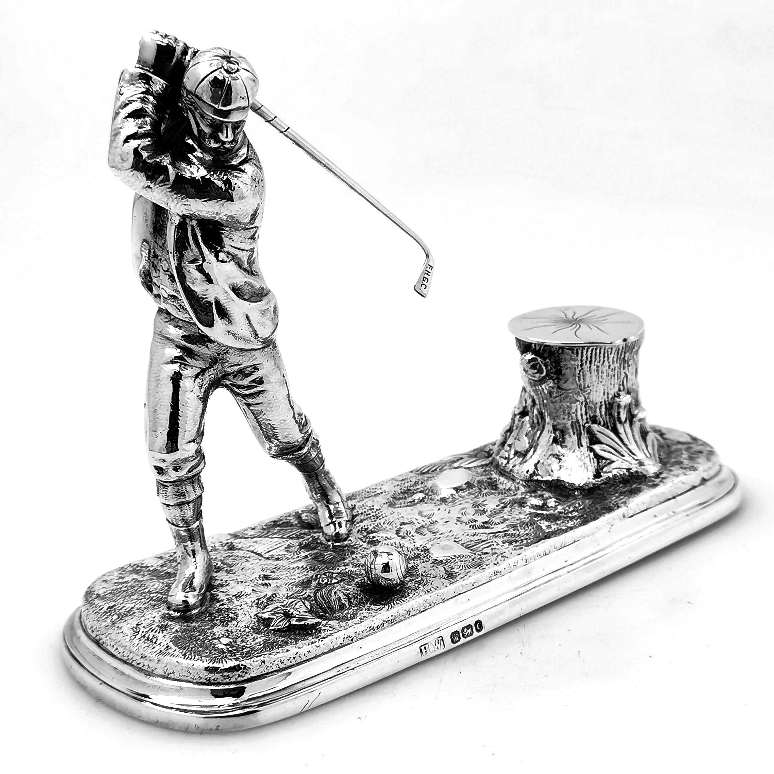 An extremely rare antique Victorian solid silver inkwell or inkstand showing the figure of a golfer swinging his club at a golf ball. The Inkwell is designed to look like a tree stump and has a glass liner. This is a highly collectable and unique